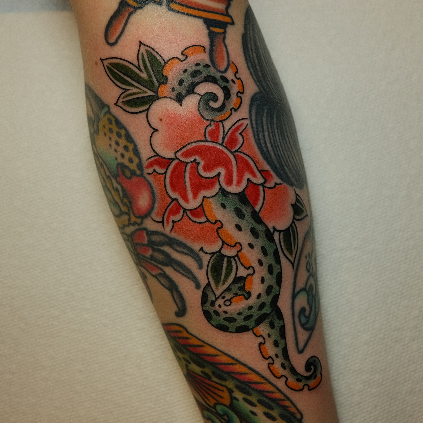 Peony and dragon American traditional tattoo on the forearm by Tony Talbert, Fredericksburg, Virginia