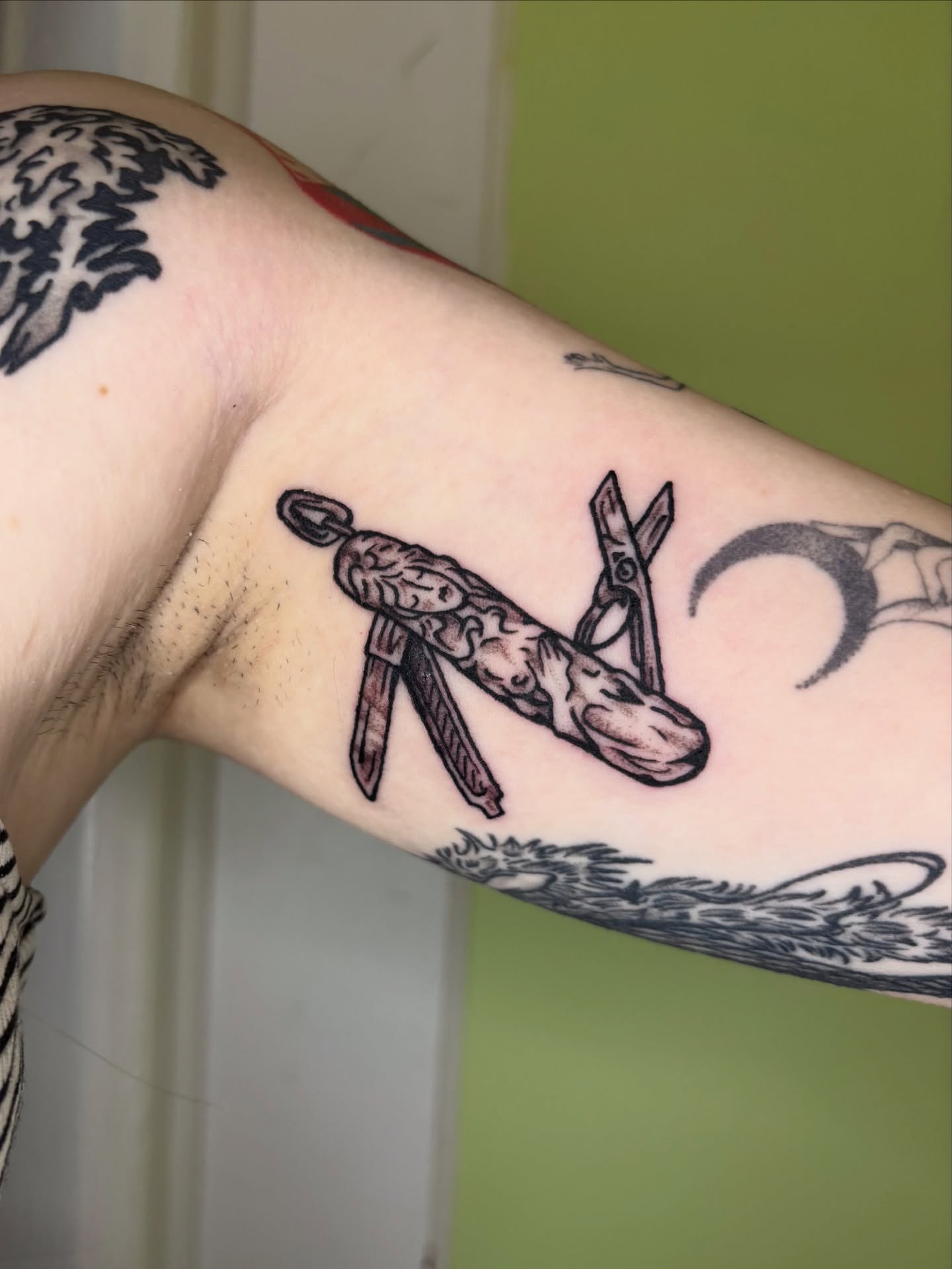 Knife and skull black and grey tattoo on the forearm by Grae