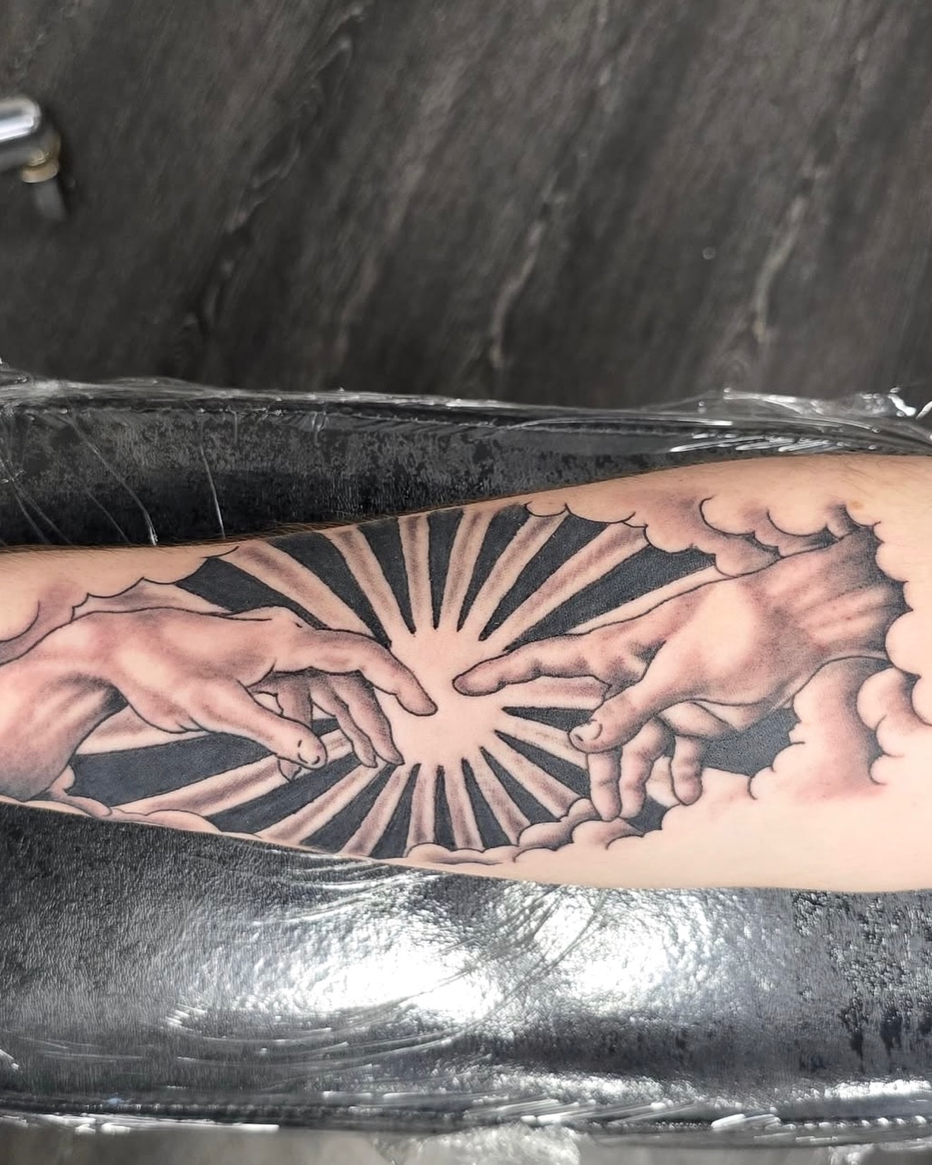 Creation scene realism tattoo on the forearm by Columbus tattoo artist