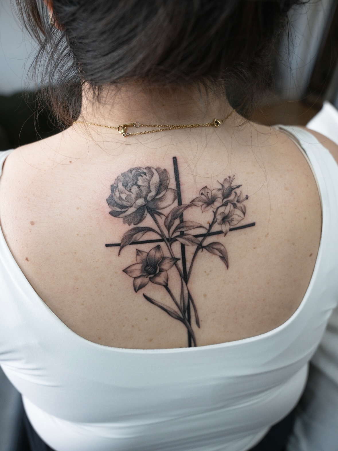 Flower and cross realism tattoo on the back by Christopher Espino, Hawthorne, California