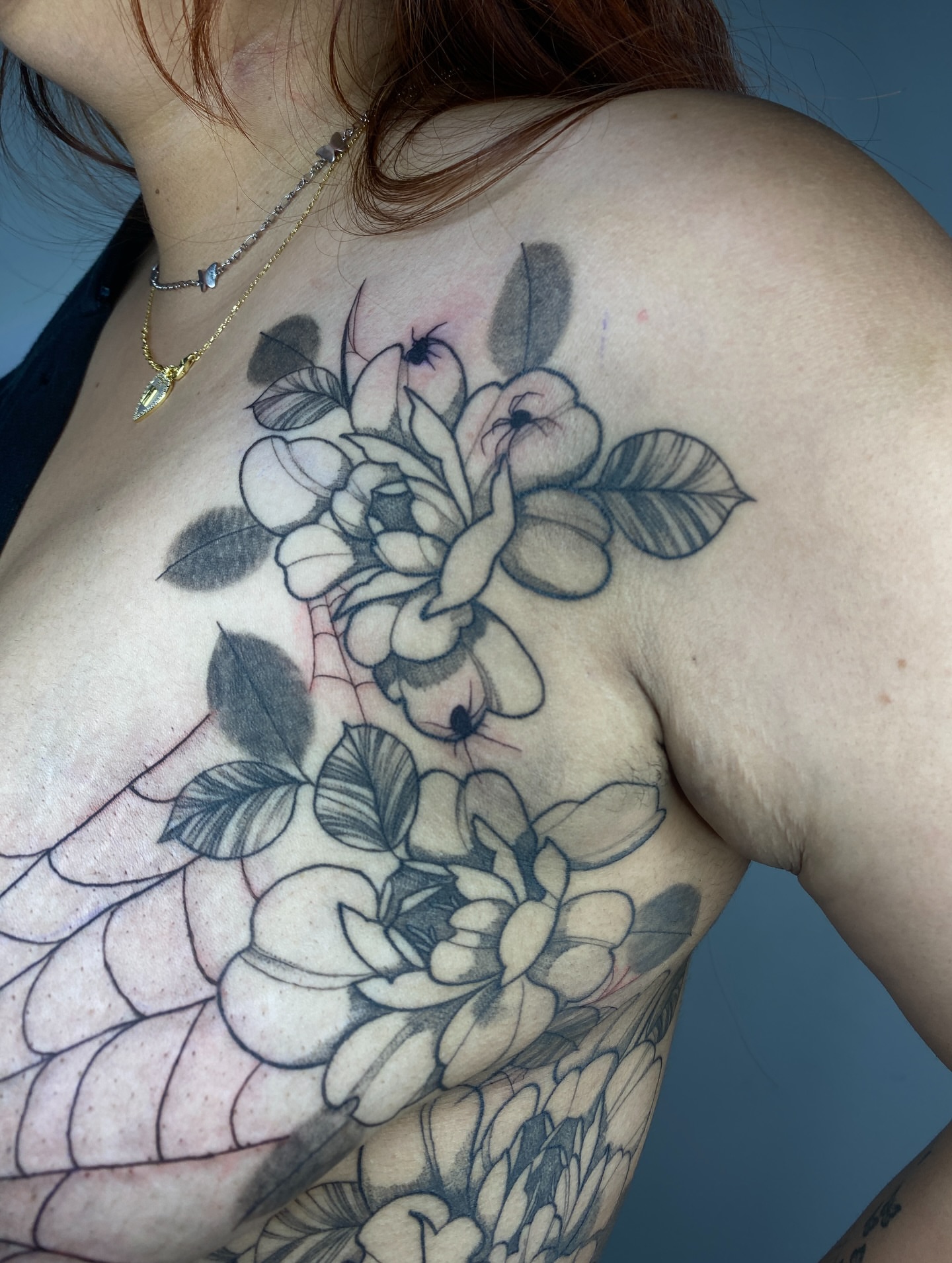 Flowers black and grey tattoo on the shoulder by Nikole