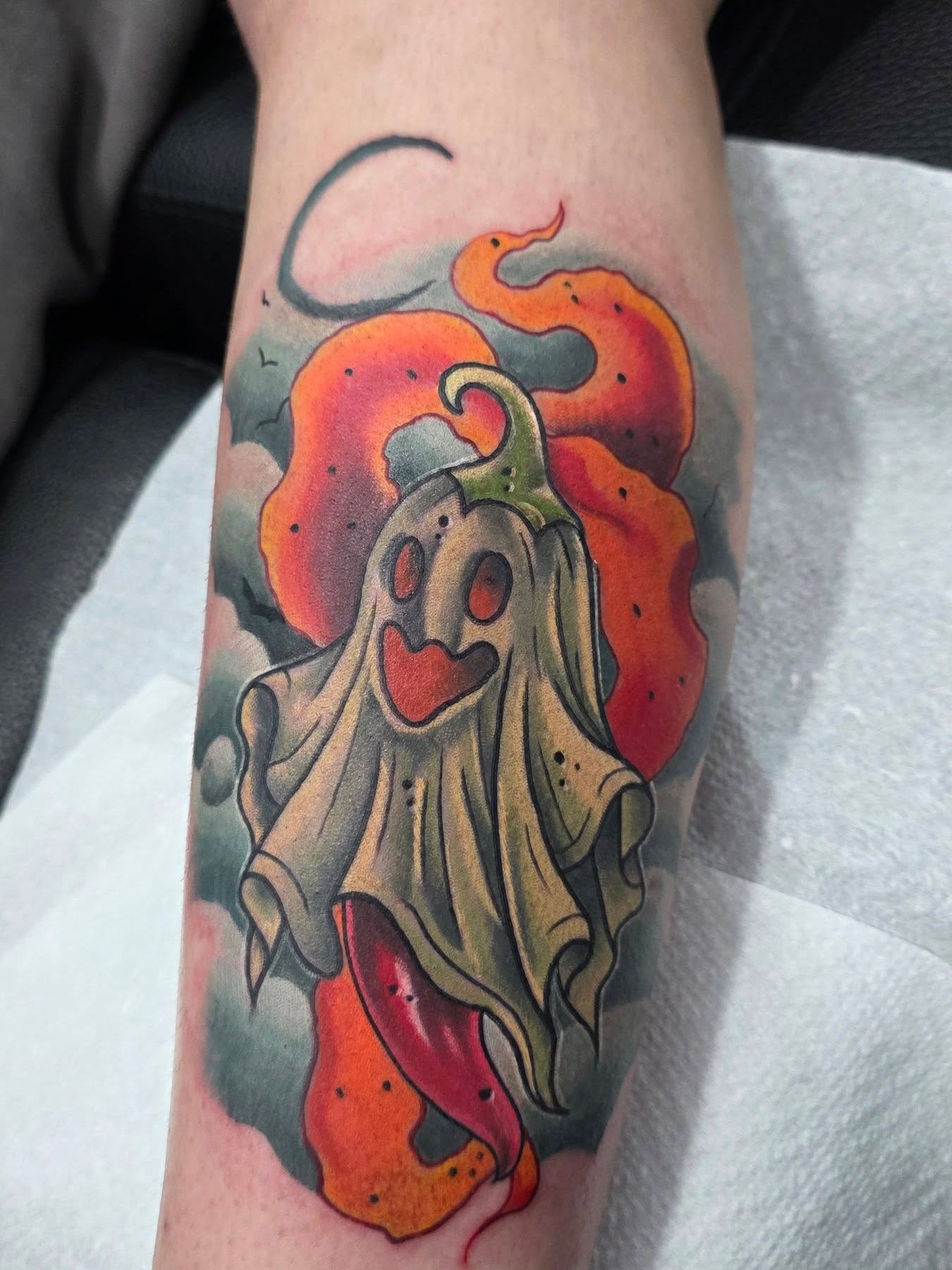 Ghost with pumpkin American traditional tattoo on the forearm by Black Lantern Tattoo Company, Niantic, Connecticut