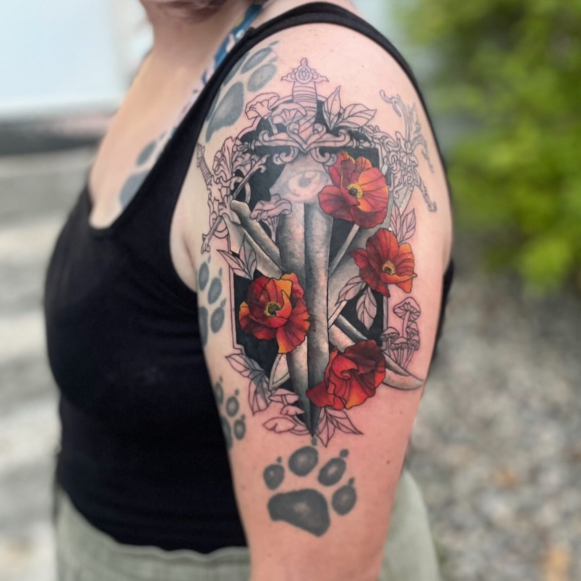 Flowers and paw print dotwork tattoo on the upper arm by Linzi Hungerford, Bozeman, Montana