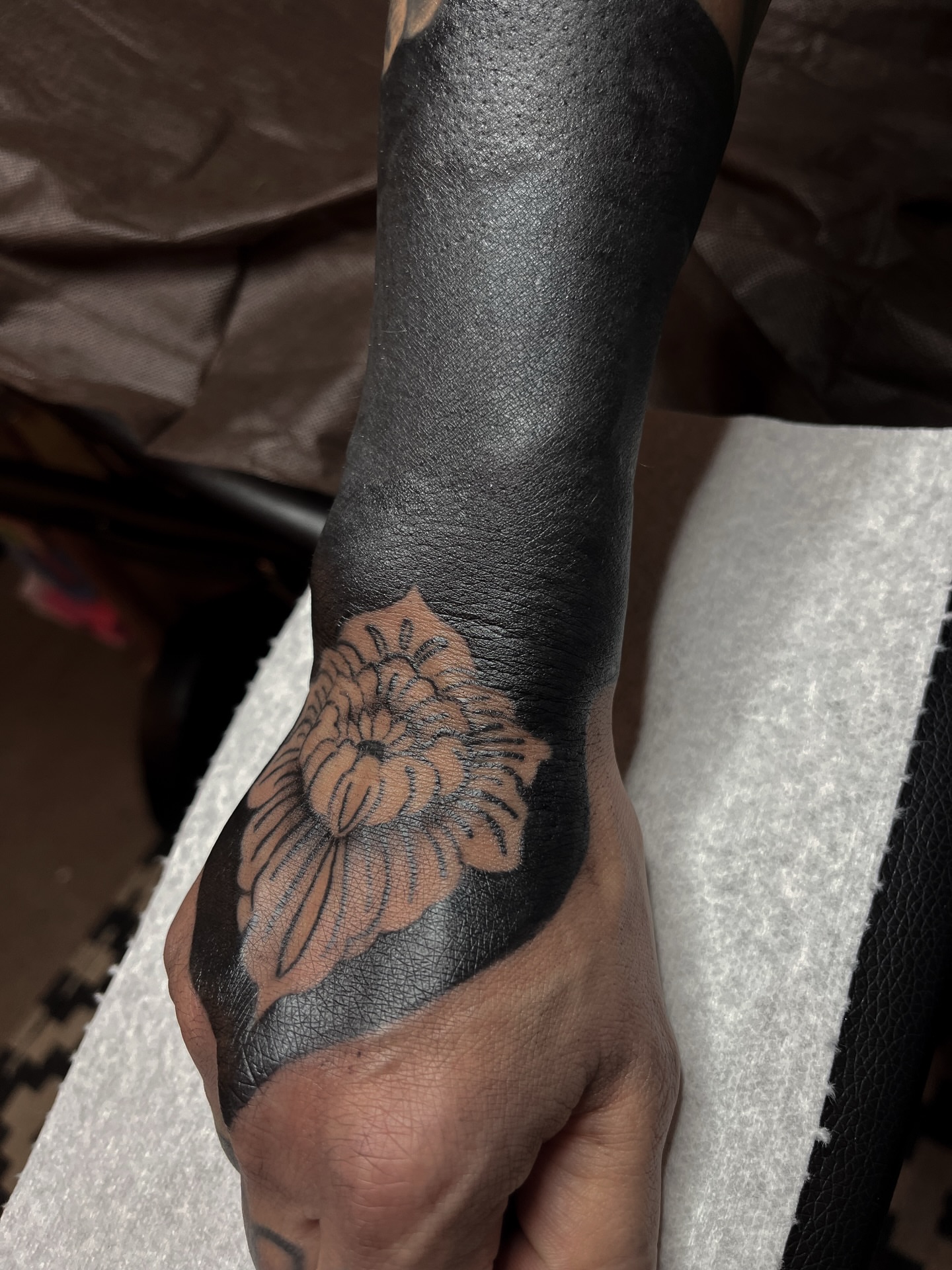 Flower black and grey tattoo on the hand by ⚜️Embodied Tattoo⚜️, Columbus, Ohio