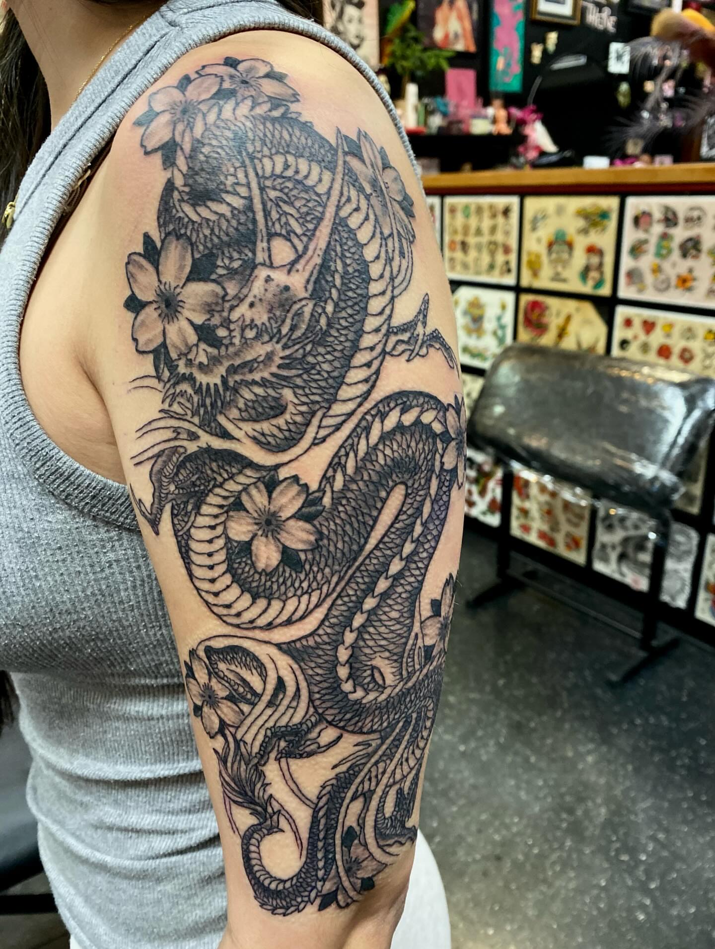 Dragon and flowers japanese irezumi tattoo on the upper arm by Las Vegas Tattoo Artist