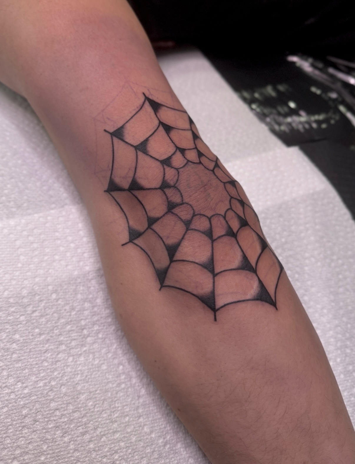 Spiderweb geometric tattoo on the forearm by Ethan, Toledo, Ohio