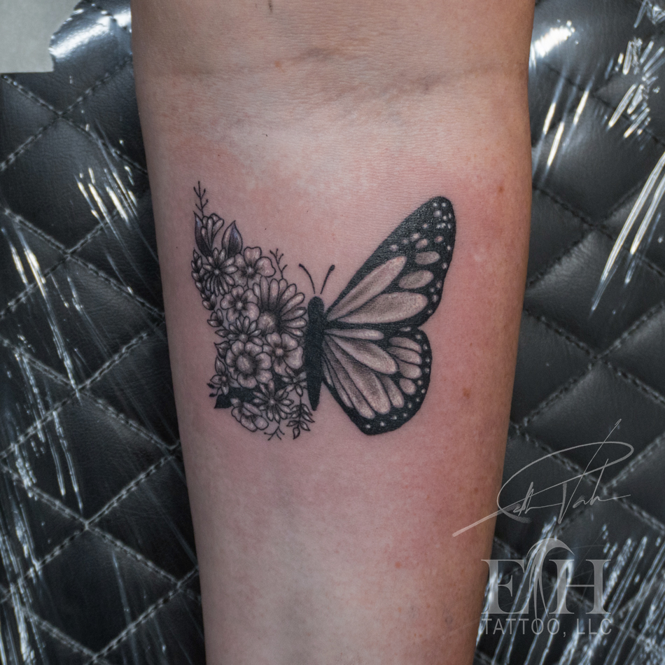 Butterfly and flowers fine line tattoo on the forearm by Donald Voelker