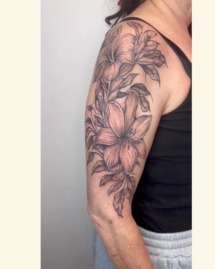 Lily half sleeve tattoo fine line tattoo on the upper arm by Van Cleave Aesthetics, Franklin, Tennessee