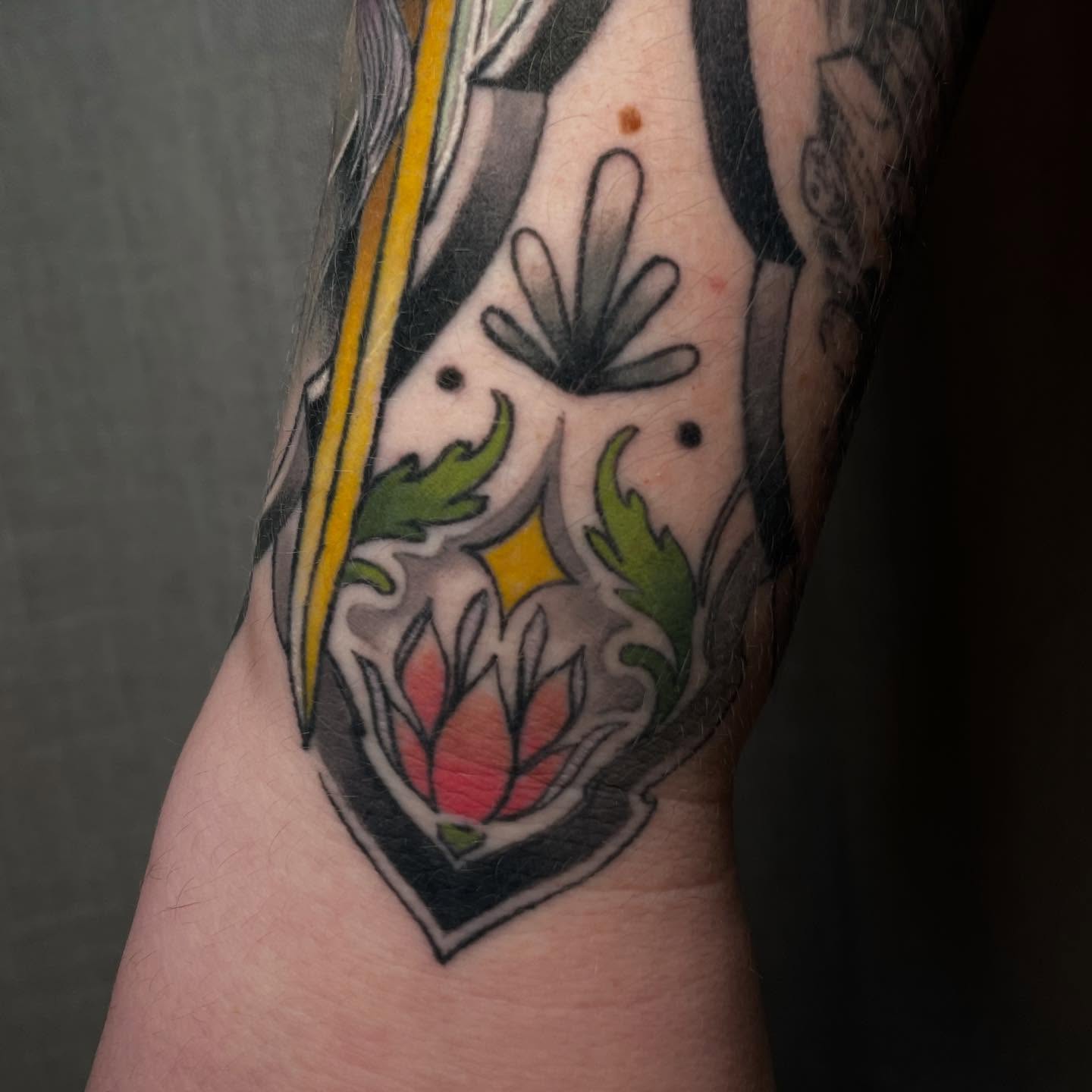 Lotus flower American traditional tattoo on the forearm by Reagan Mauldin