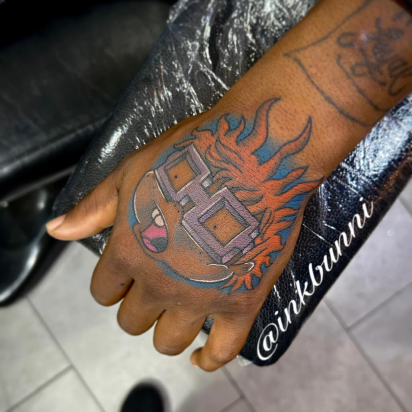 Flame and shield new school tattoo on the hand by Hailey Aka inkbunni, Detroit, Michigan