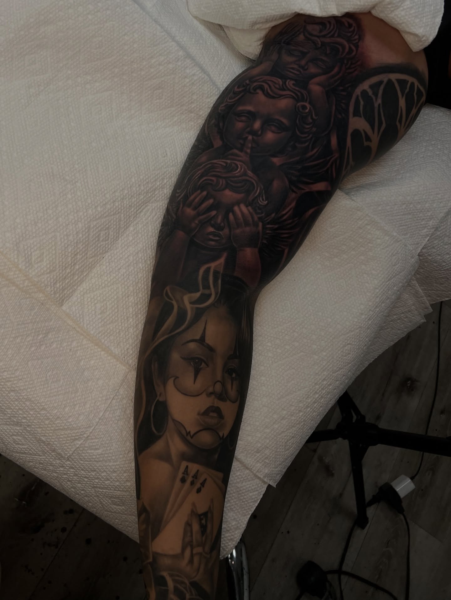 Woman with playing card realism tattoo on the forearm by Daniel Michael Perez