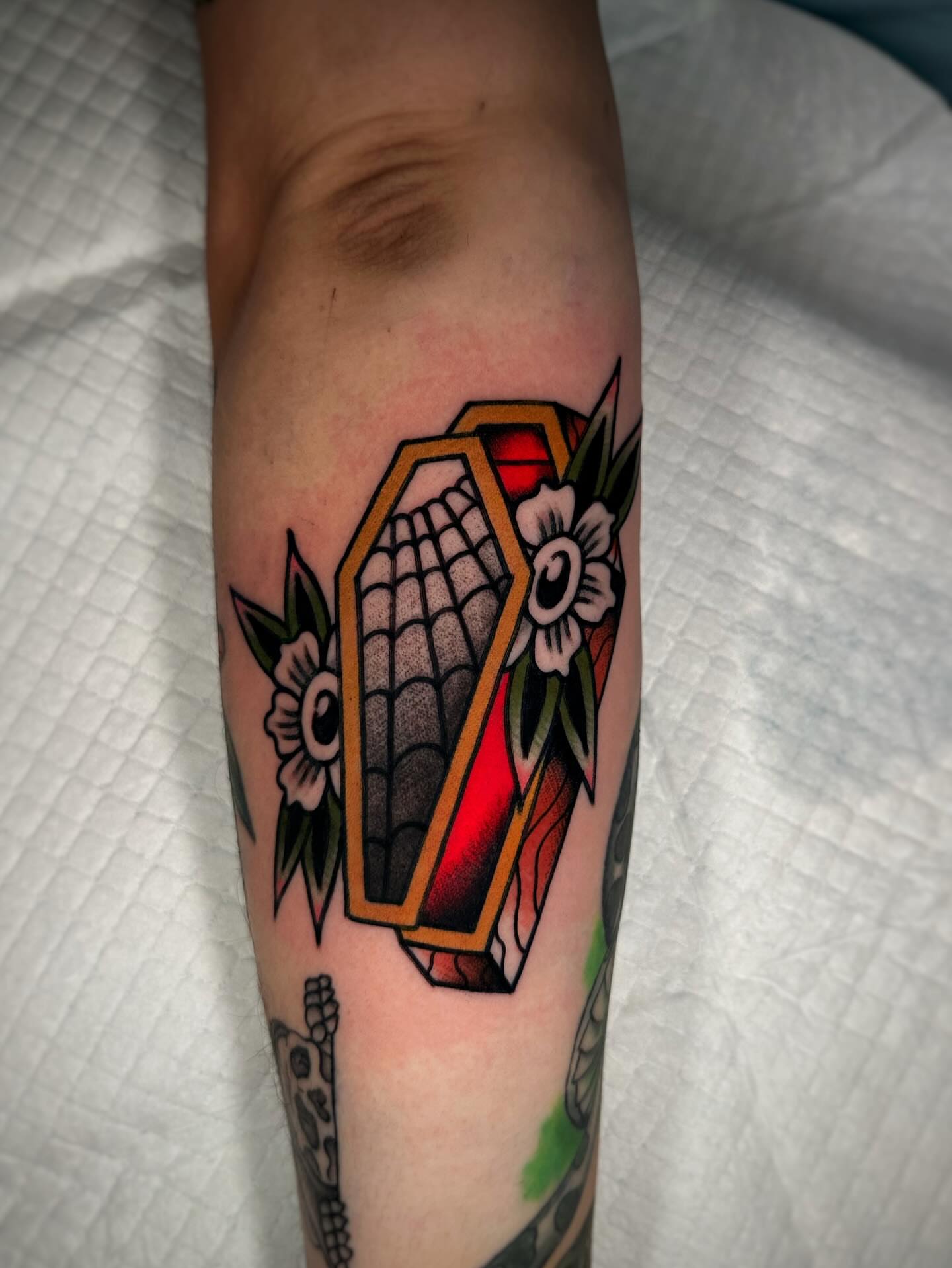 Geometric coffin American traditional tattoo on the forearm by Alex Finnerty, Reading, Massachusetts