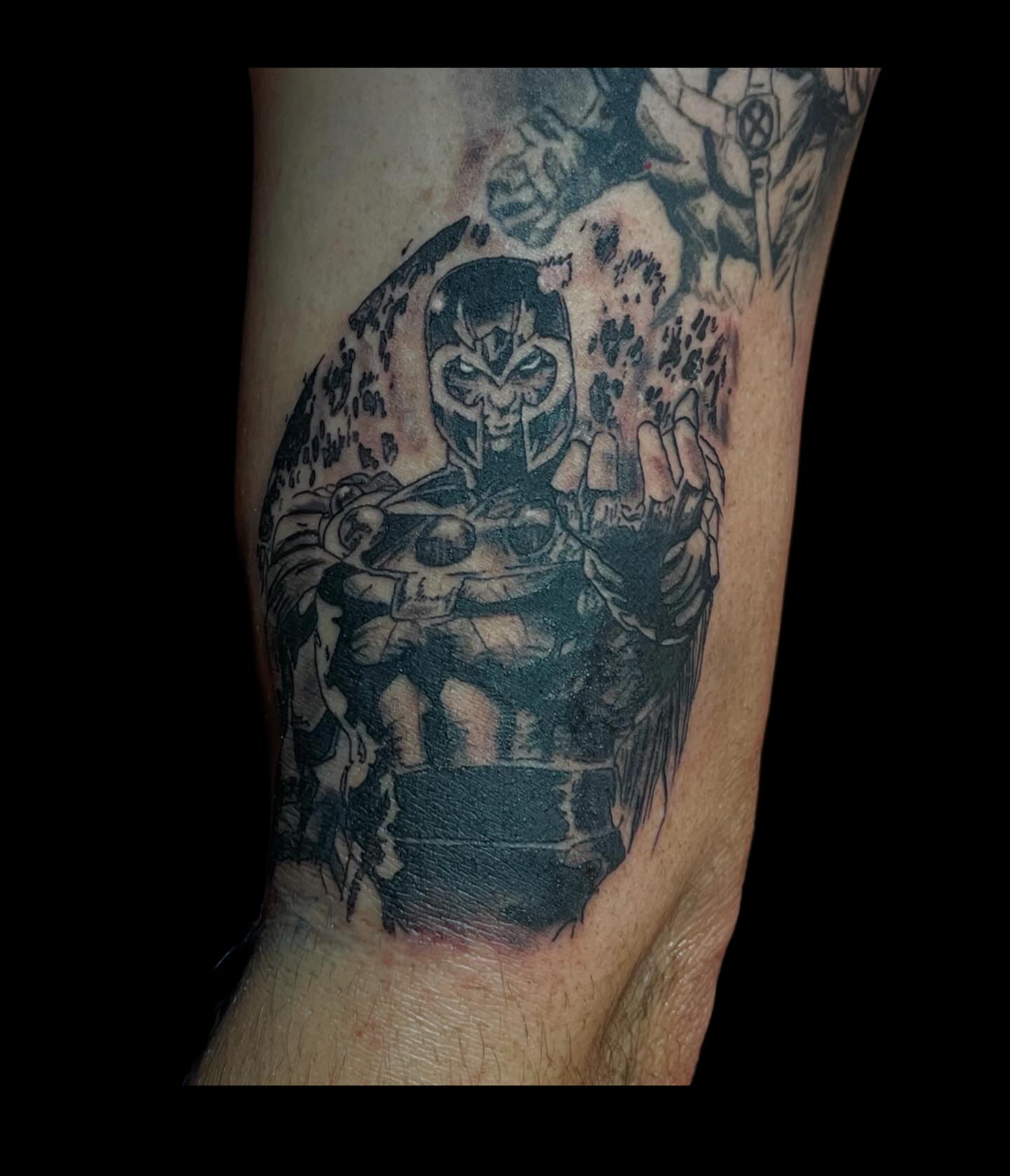 Magneto black and grey tattoo on the forearm by Dev