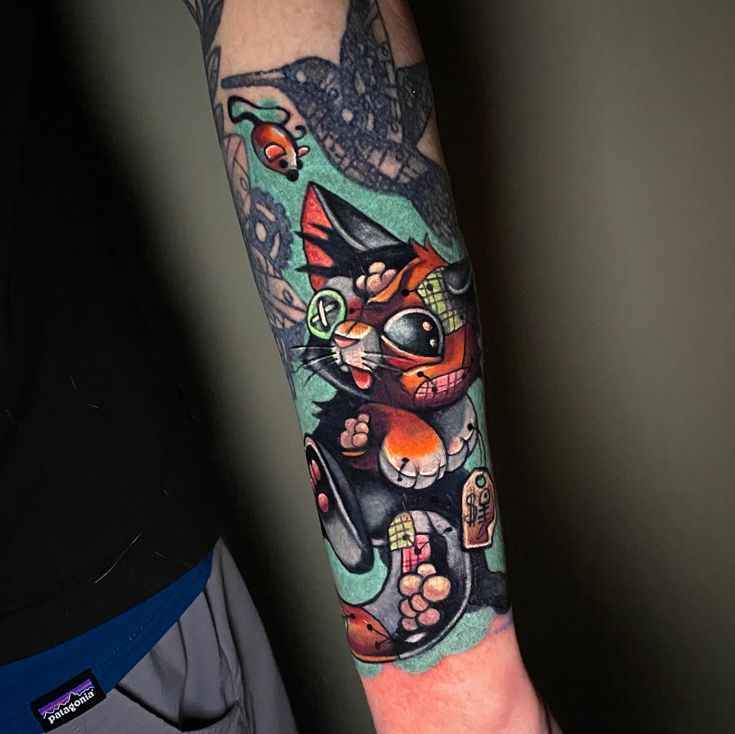 Cat American traditional tattoo on the forearm by Lindsay Hall