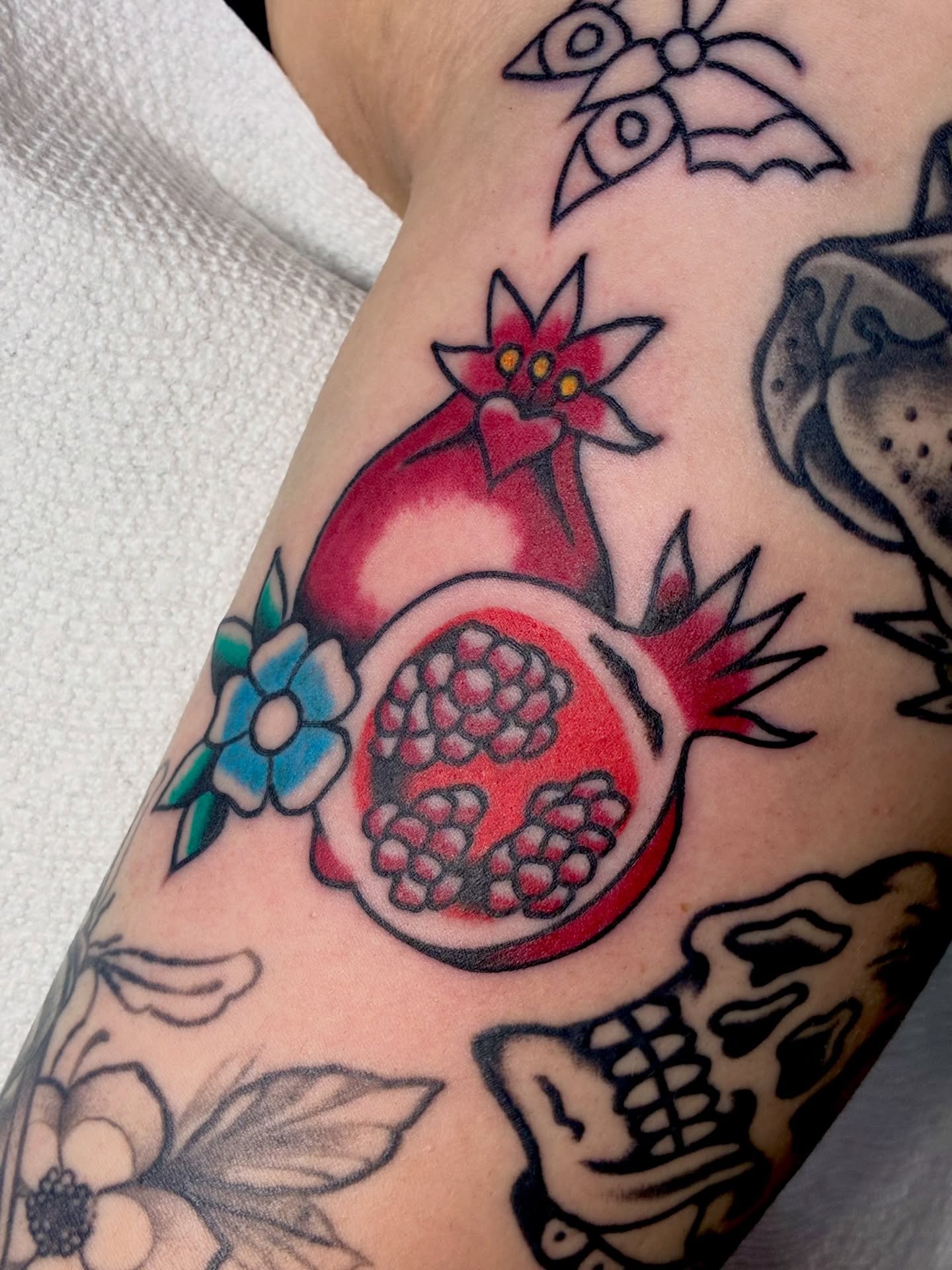Pomegranate American traditional tattoo on the forearm by Sav Robinson