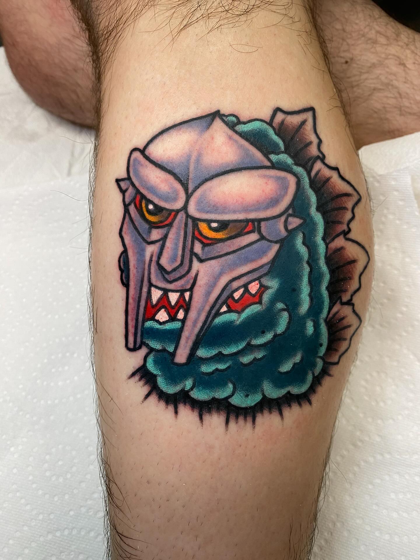 Mask American traditional tattoo on the thigh by Brandon Heredia, Vacaville, California