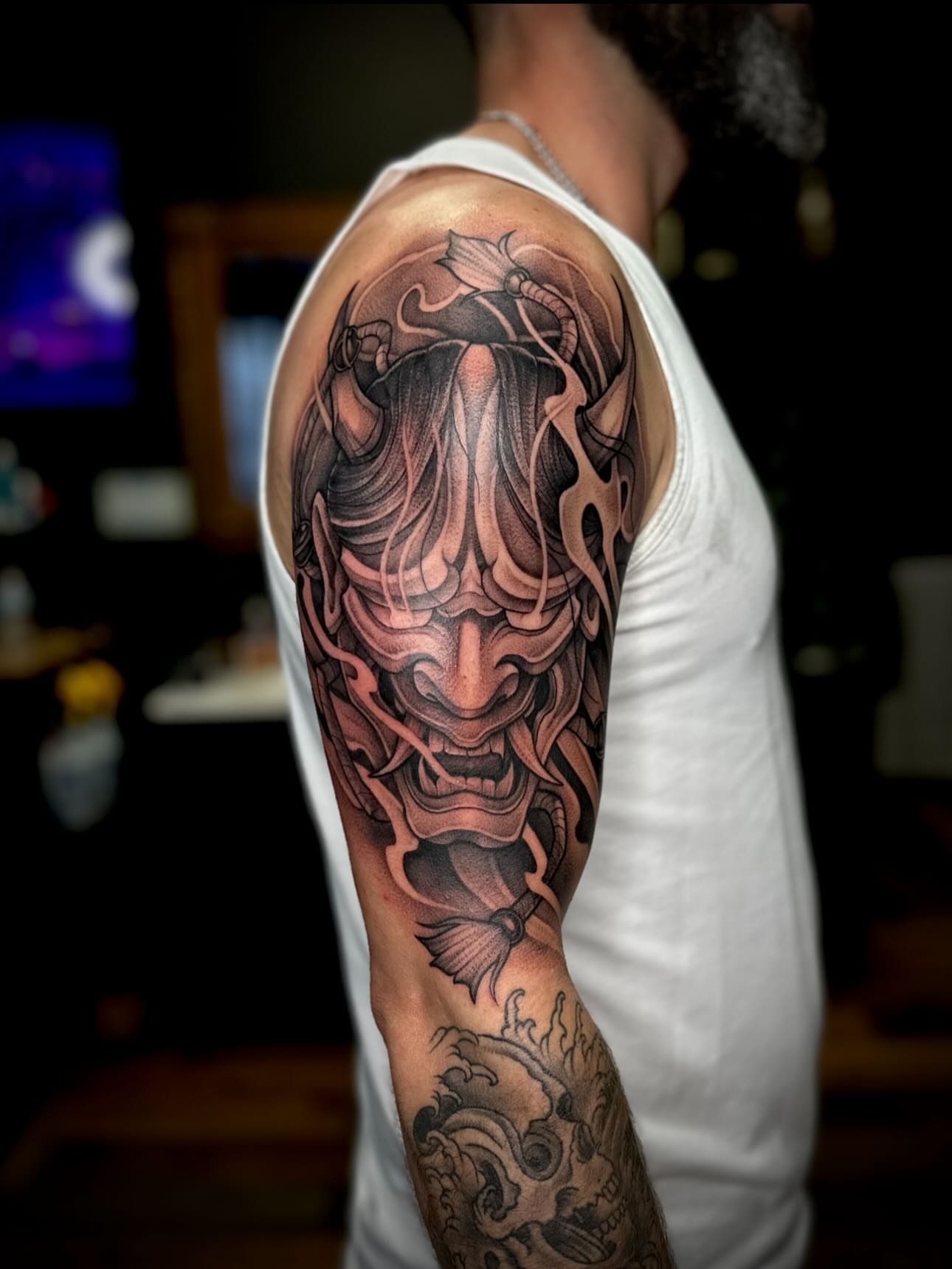 Mask japanese irezumi tattoo on the upper arm by Madison Orchard Tattoos