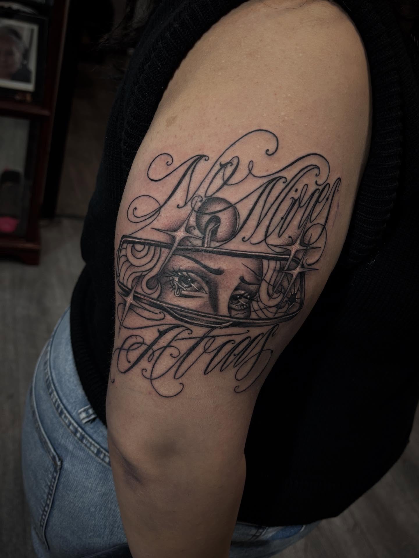 Football helmet and eyes realism tattoo on the shoulder by michael