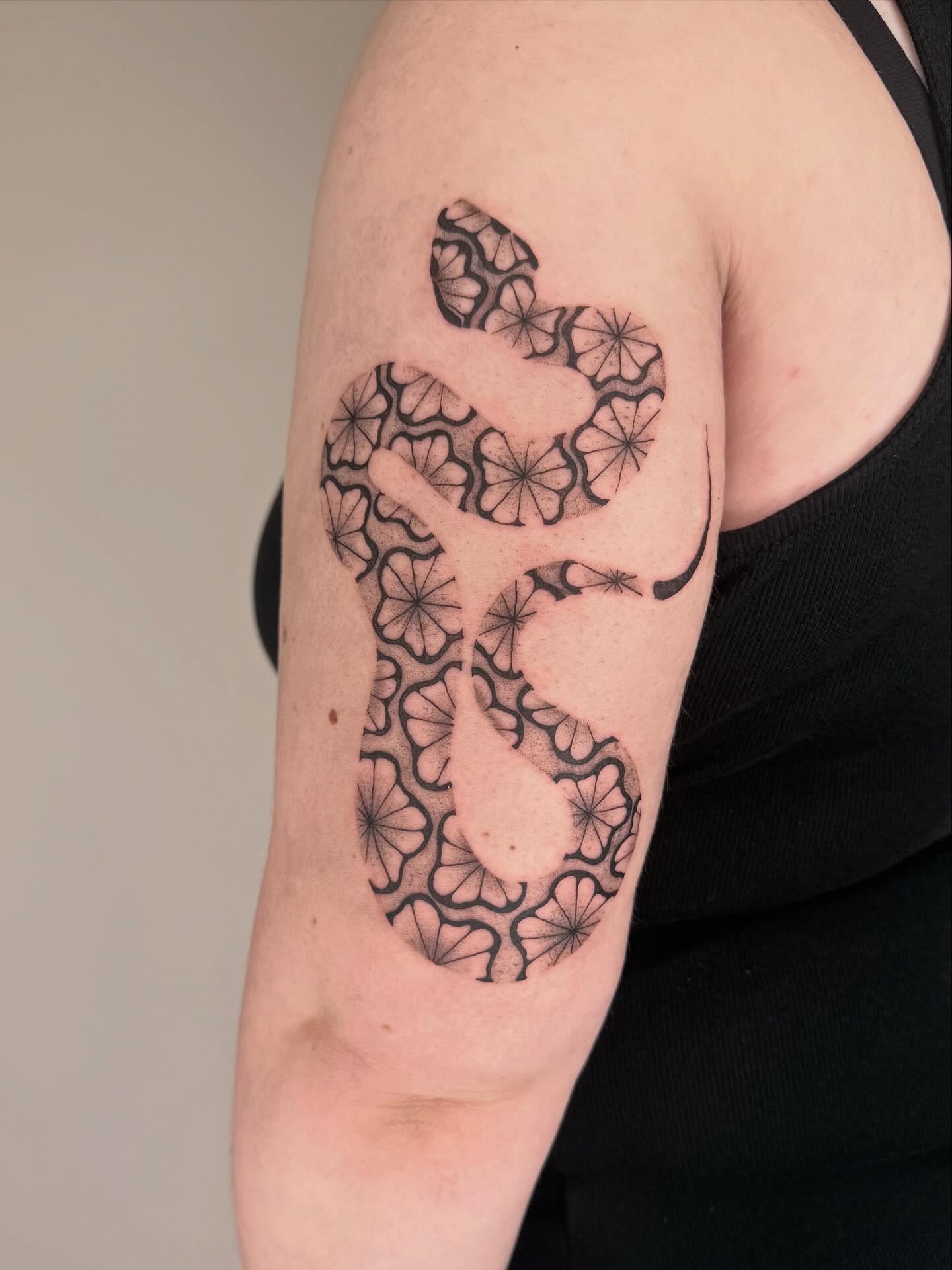 Geometric pattern geometric tattoo on the upper arm by Leah Ramos