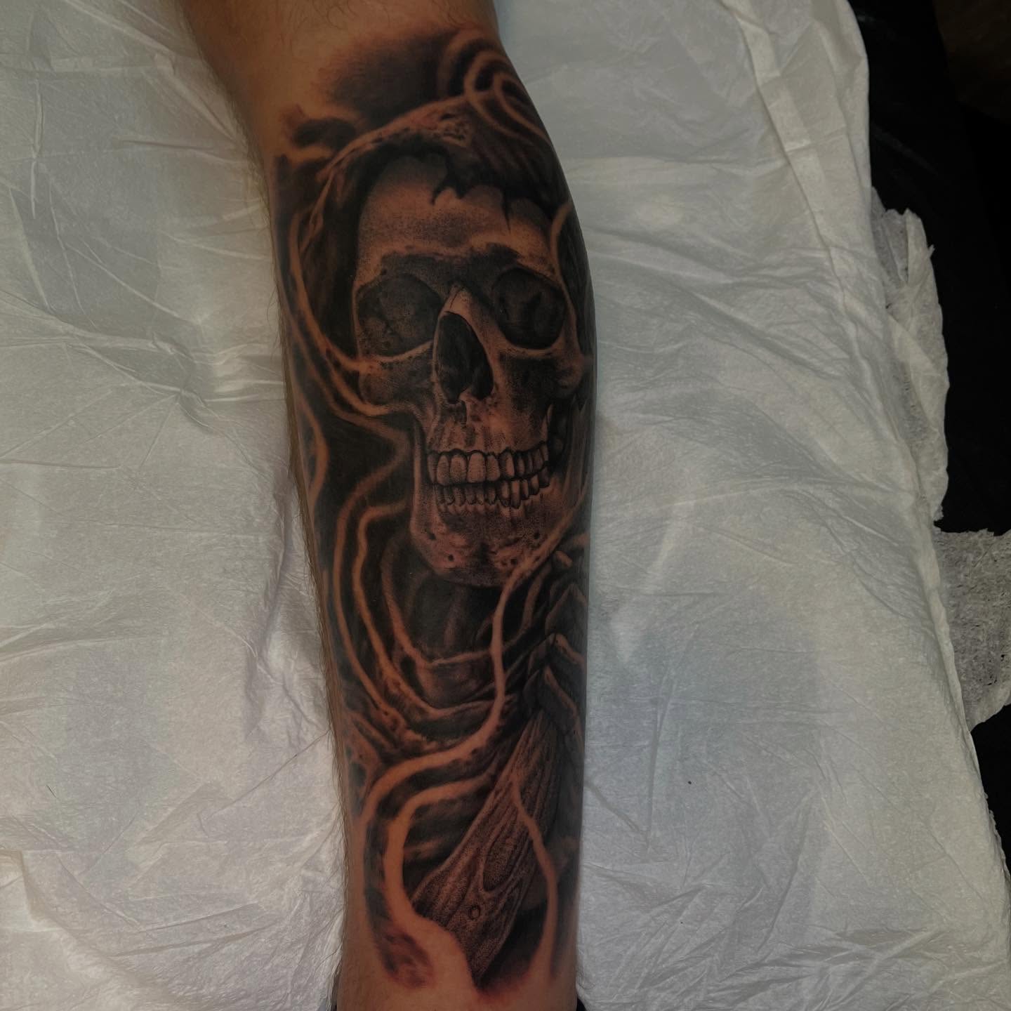 Skull realism tattoo on the forearm by Adam Habecker