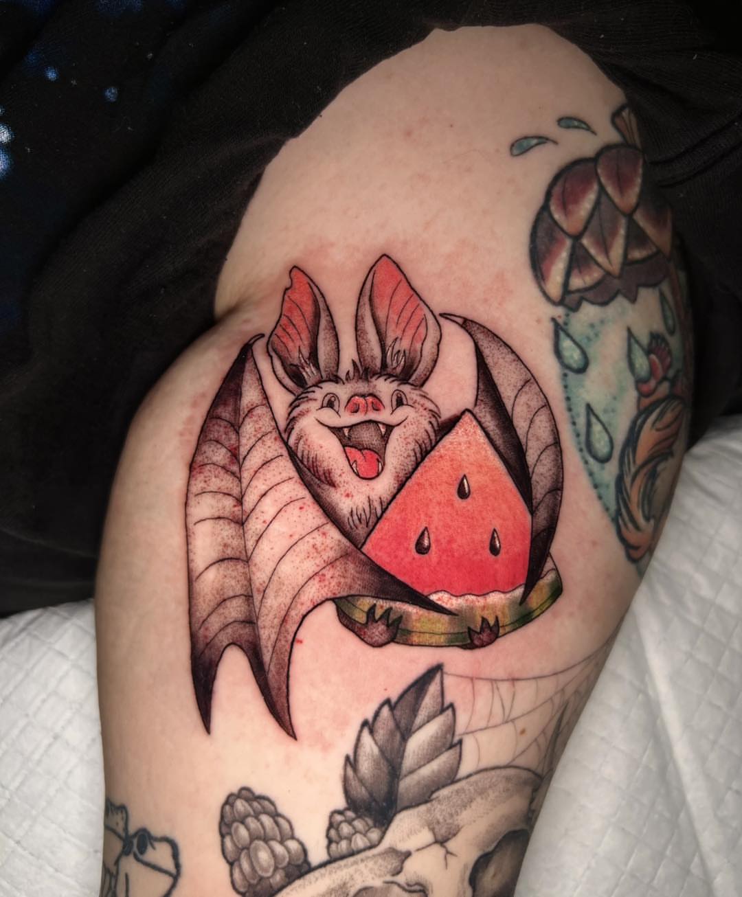 Bat and watermelon American traditional tattoo on the shoulder by Mikaela Rush, Greensboro, North Carolina