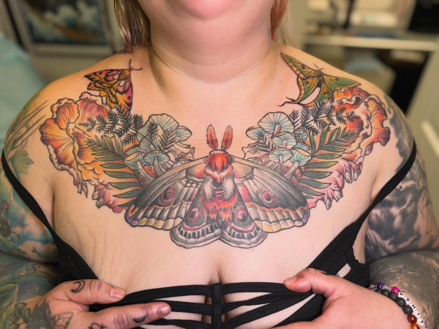 Moth and flowers new school tattoo on the chest by Vega