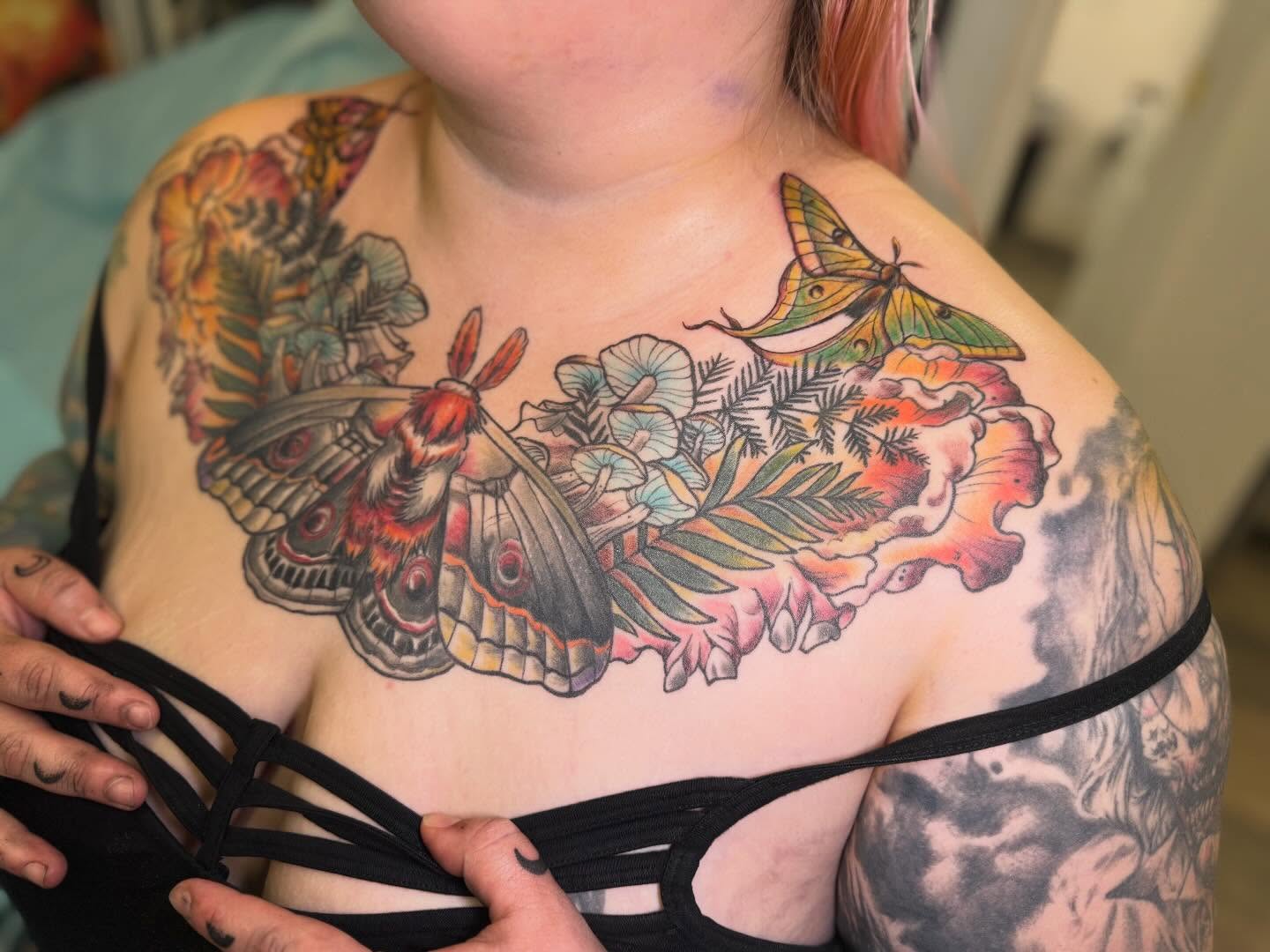 Butterfly and flowers American traditional tattoo on the chest by Vega