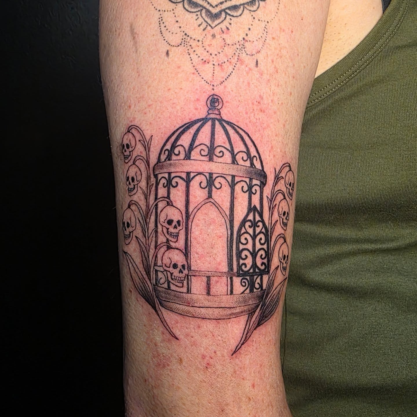 Birdcage with skulls black and grey tattoo on the forearm by 𝕷𝖚𝖈𝖎𝖉