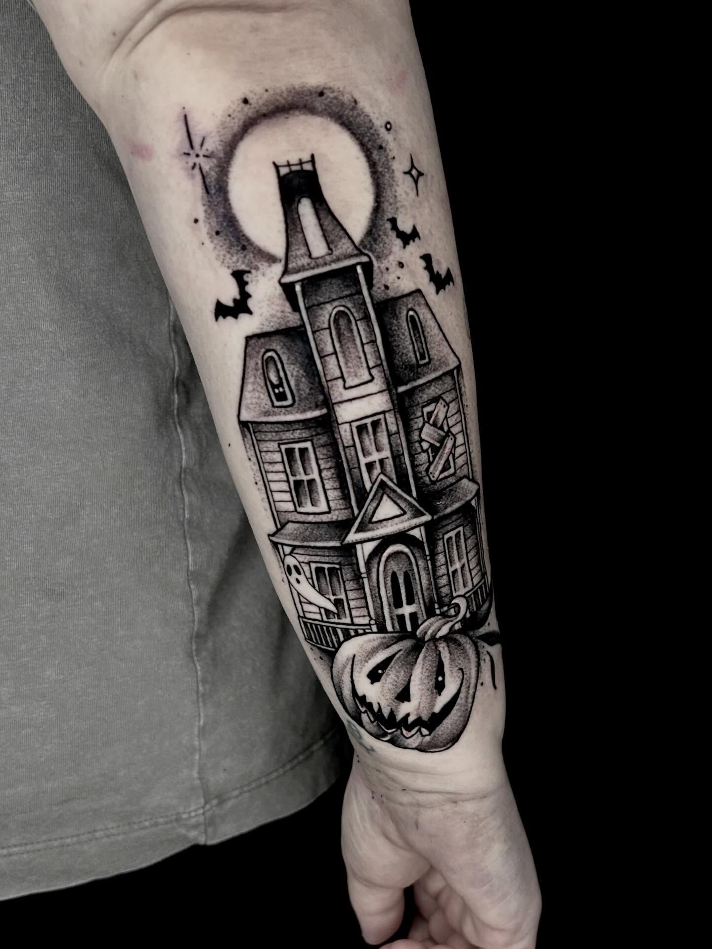 Haunted house black and grey tattoo on the forearm by Haleigh Cunningham, Charlotte, North Carolina