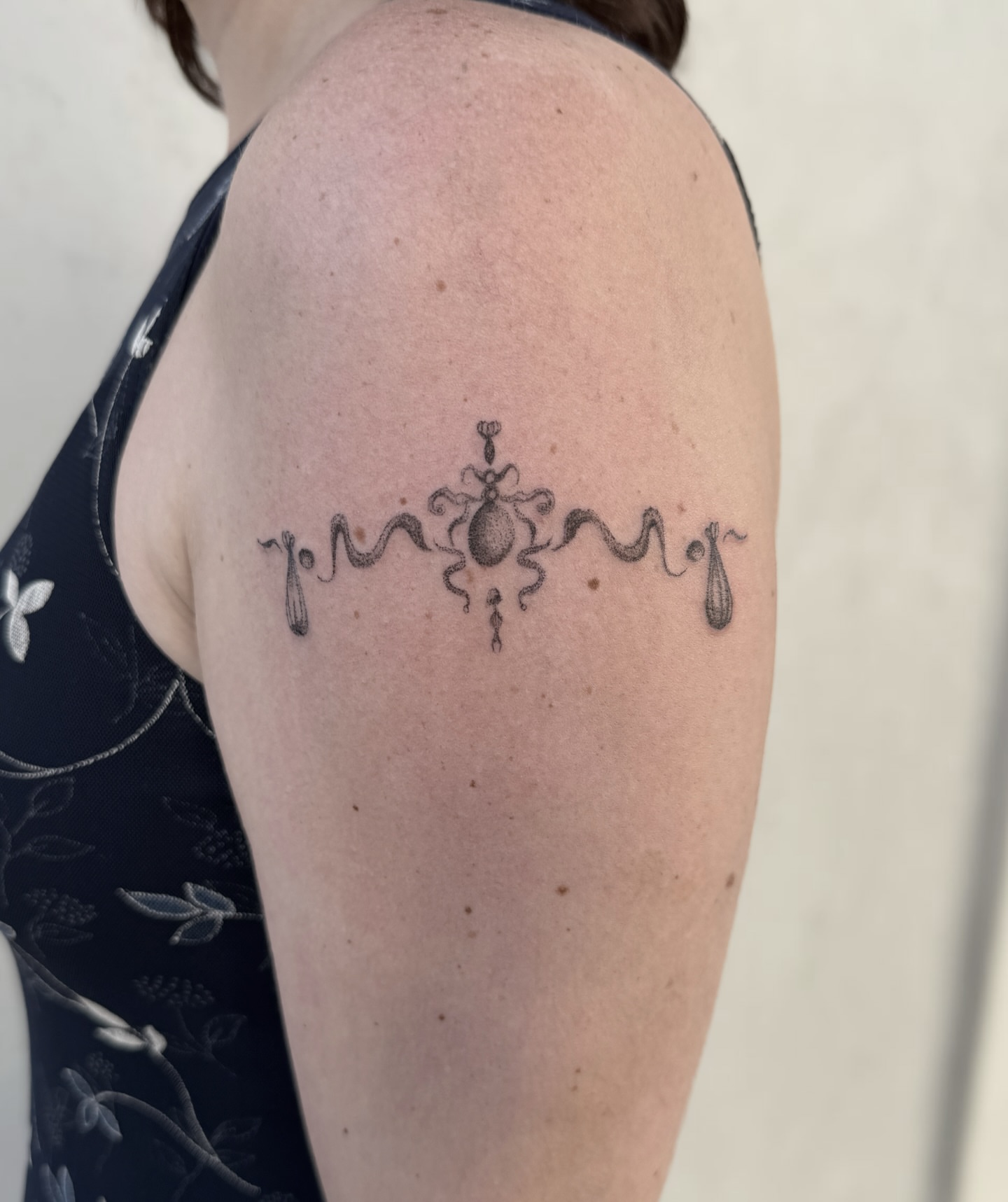 Snake and peony black and grey tattoo on the shoulder by Raleigh tattoo artist, Raleigh, North Carolina