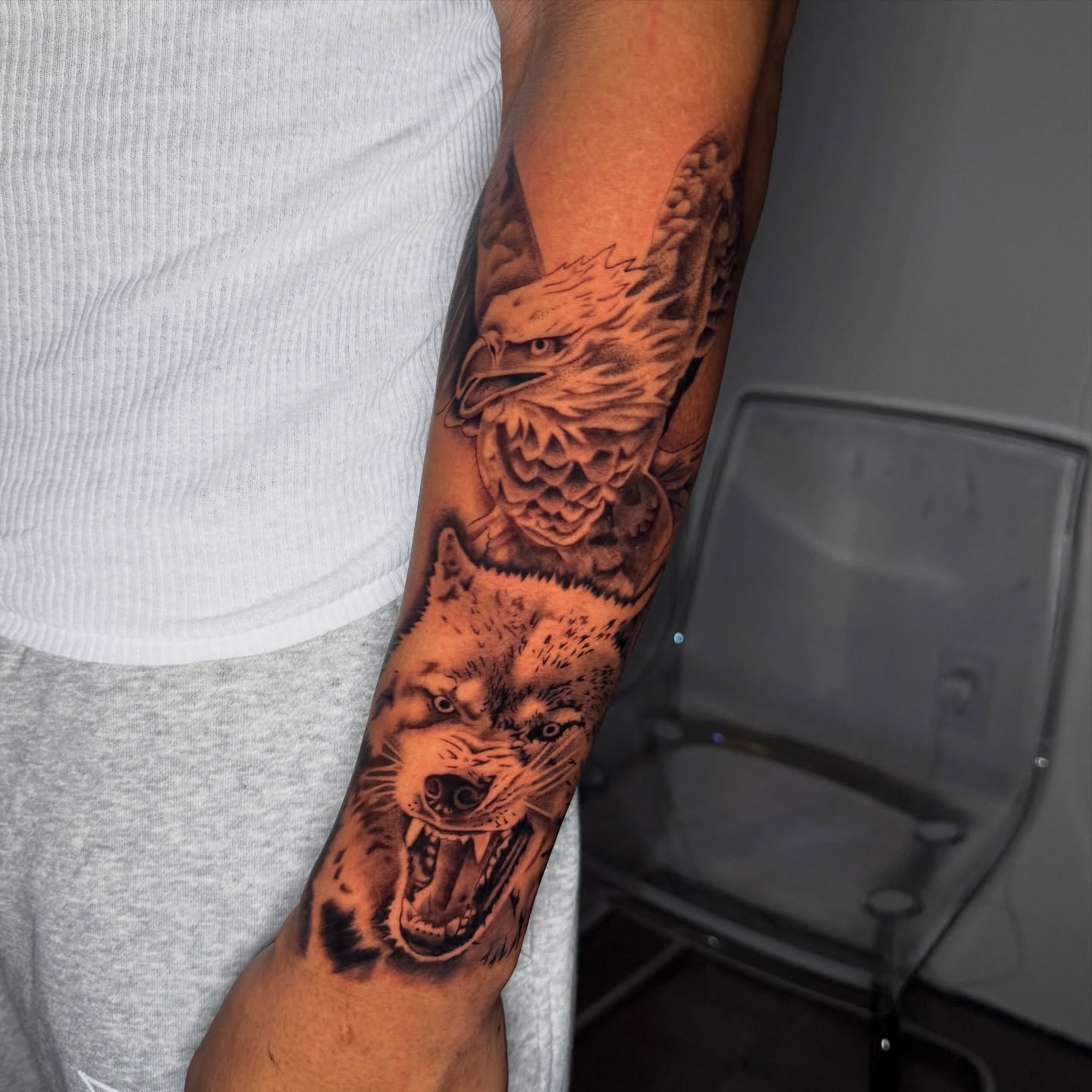Wolf and eagle realism tattoo on the forearm by Chip