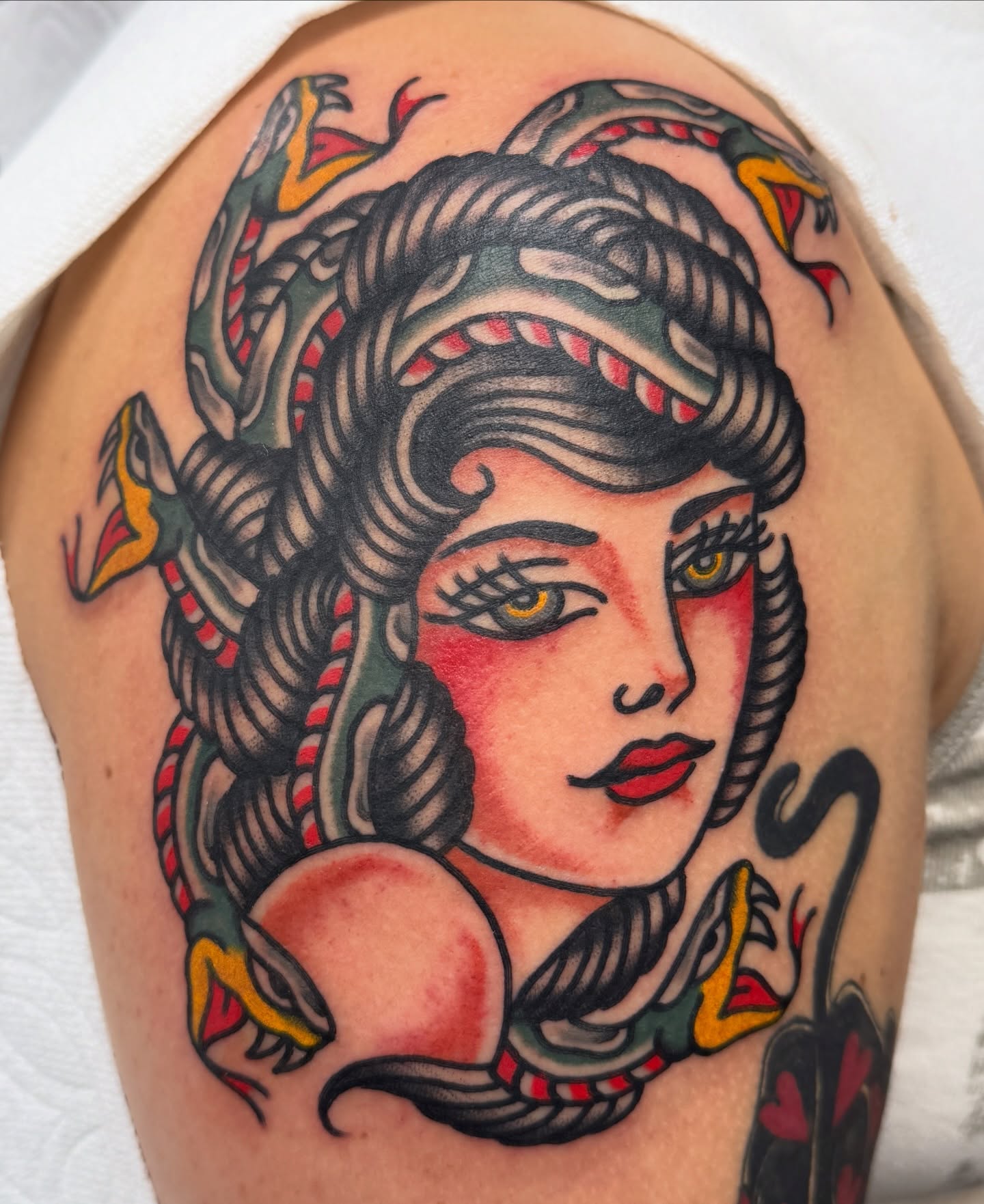 Woman with snakes American traditional tattoo on the shoulder by Joey Burdette Tattoos