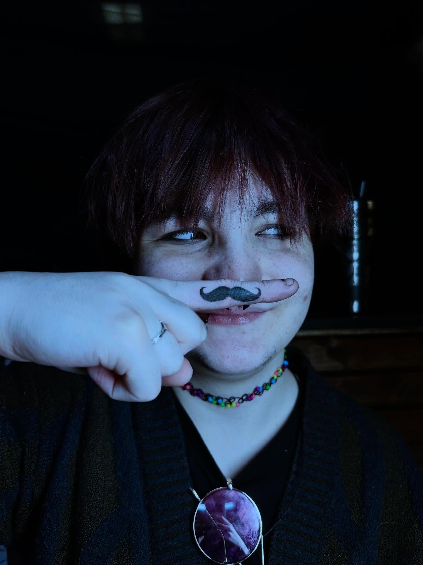 Mustache black and grey tattoo on the hand by emma christine