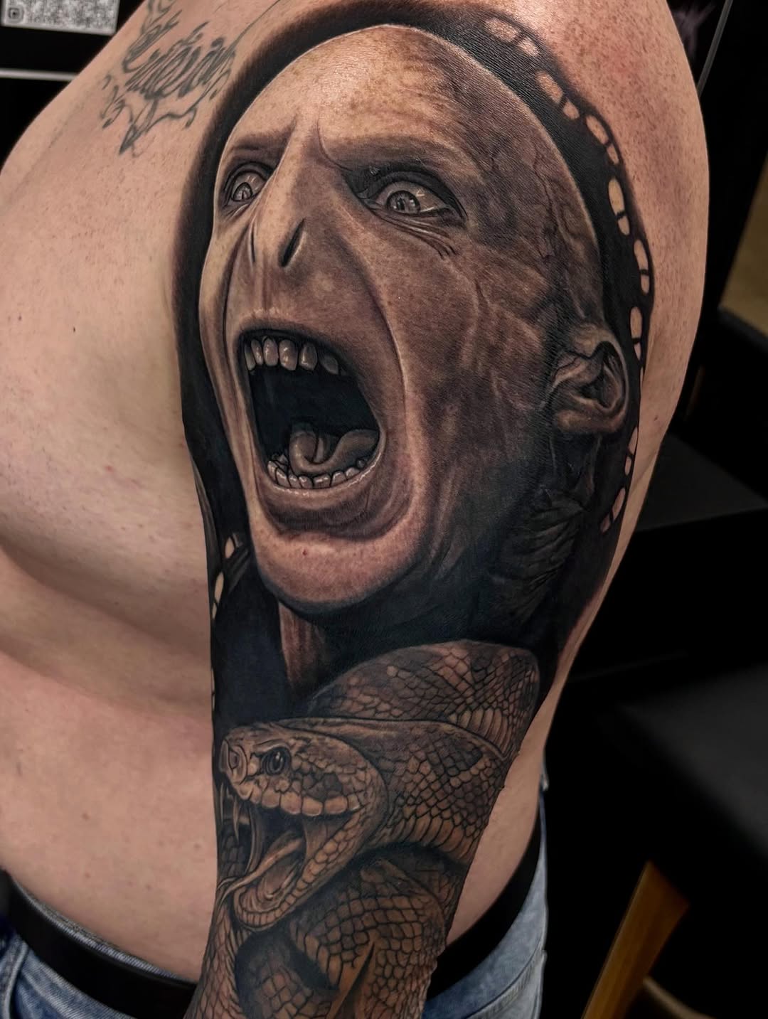Voldemort and snake surrealism tattoo on the forearm by Jayden A