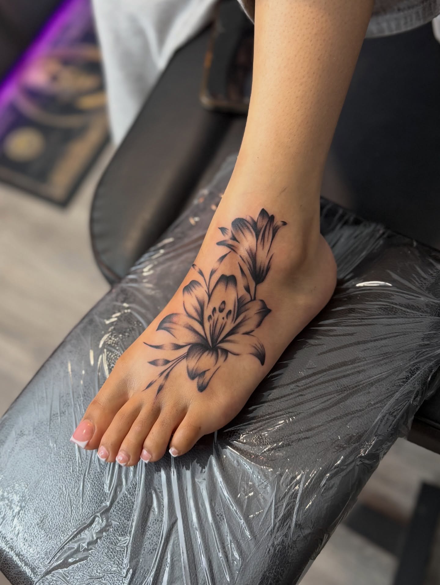 Flower black and grey tattoo on the foot by InkbyCasillas