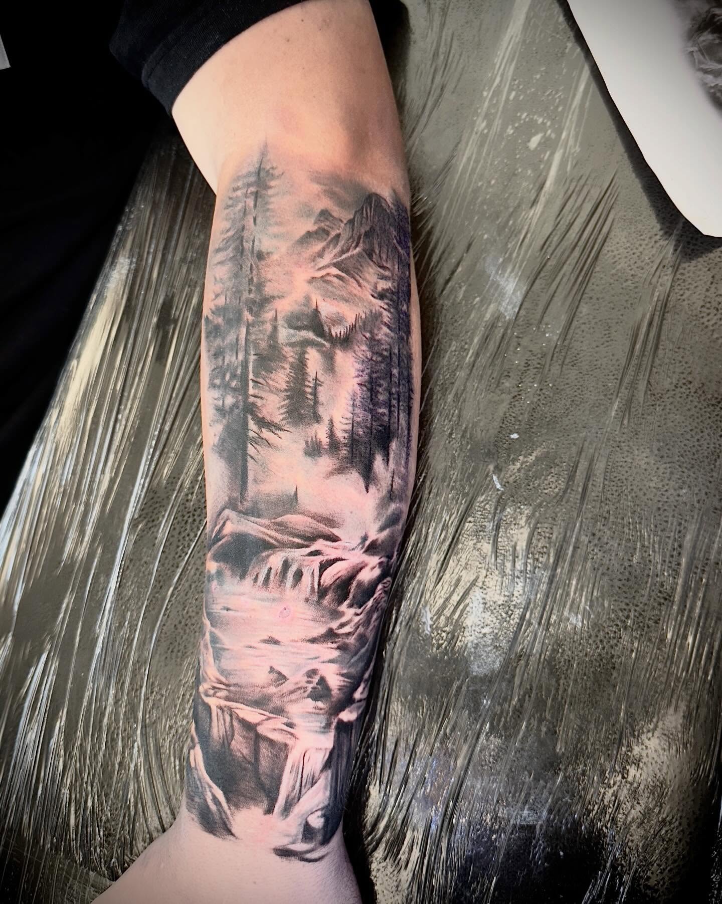 Mountain landscape realism tattoo on the forearm by Levi Tattoo Artist, Utah