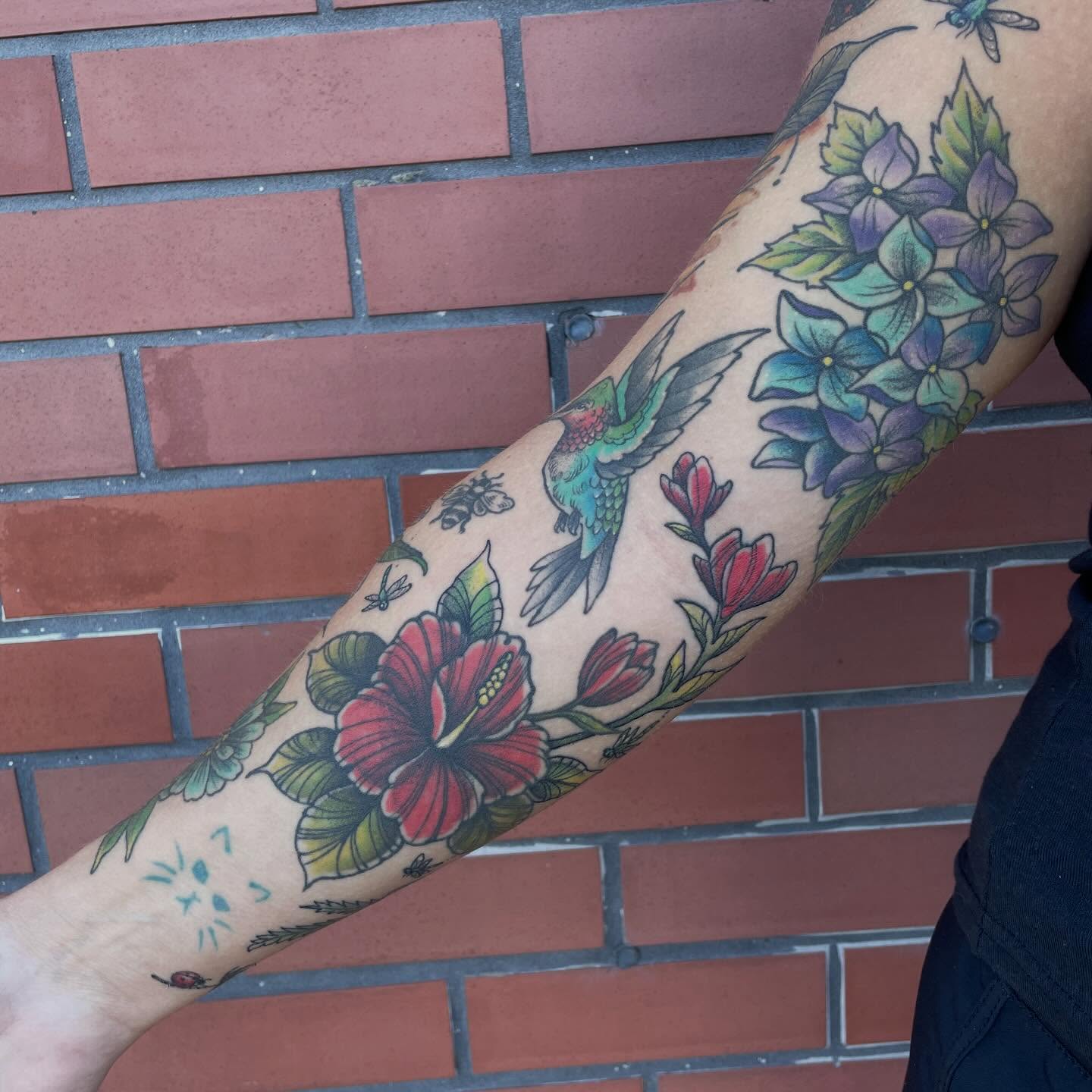 Floral arrangement American traditional tattoo on the forearm by Fionna Fanning