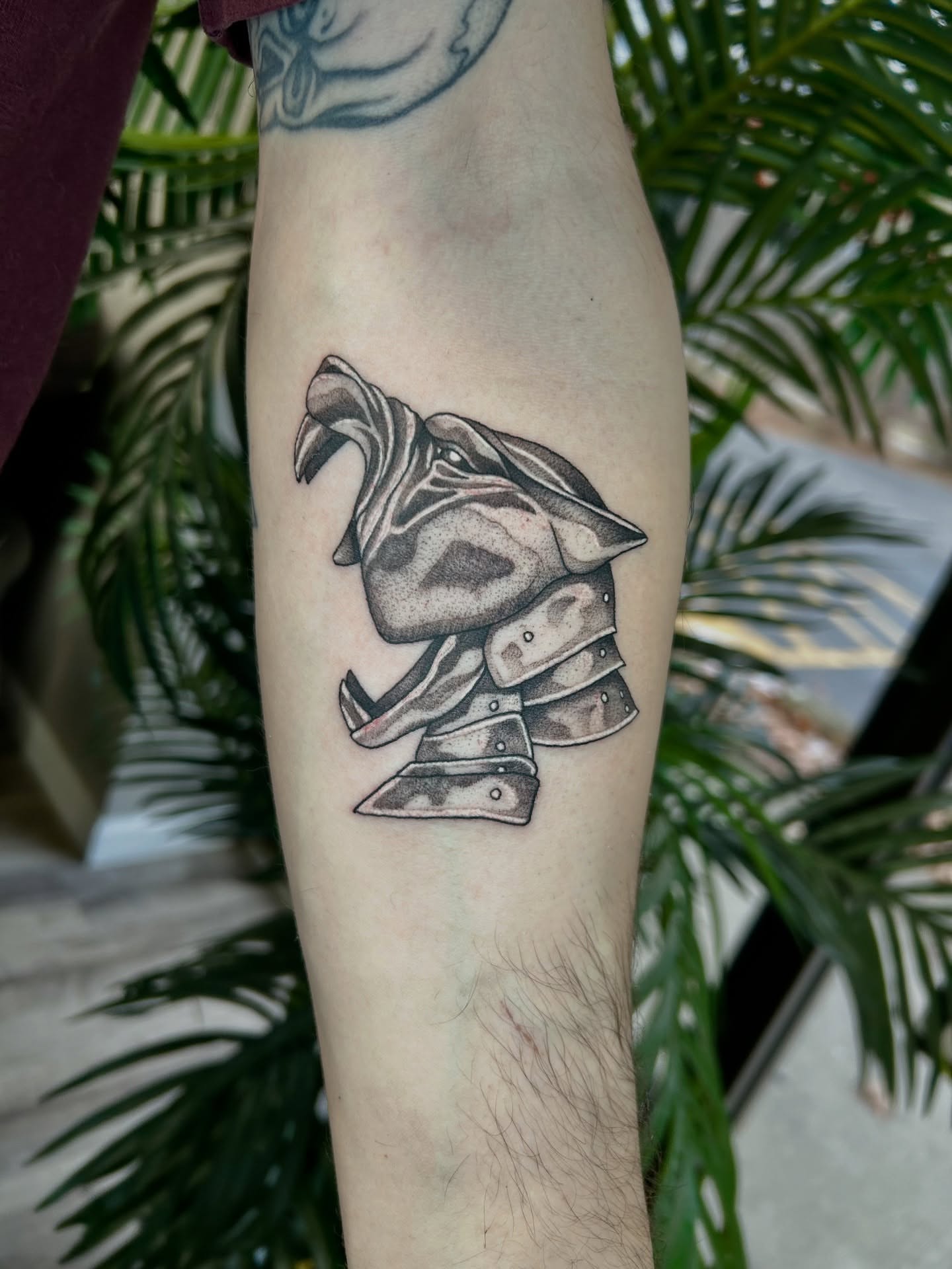 Mask with knives black and grey tattoo on the forearm by Taylor Heidtbrink