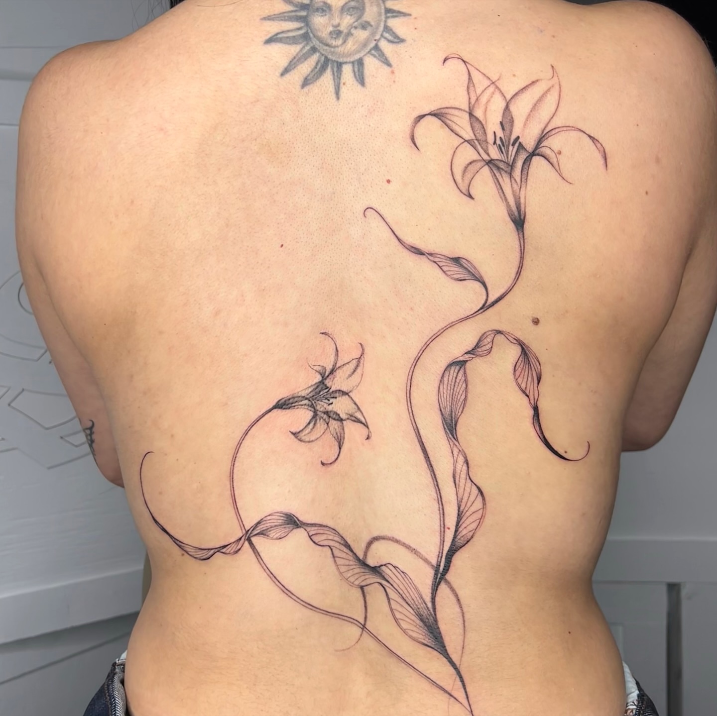 Lily flowers black and grey tattoo on the back by ✭ Elisa ✭