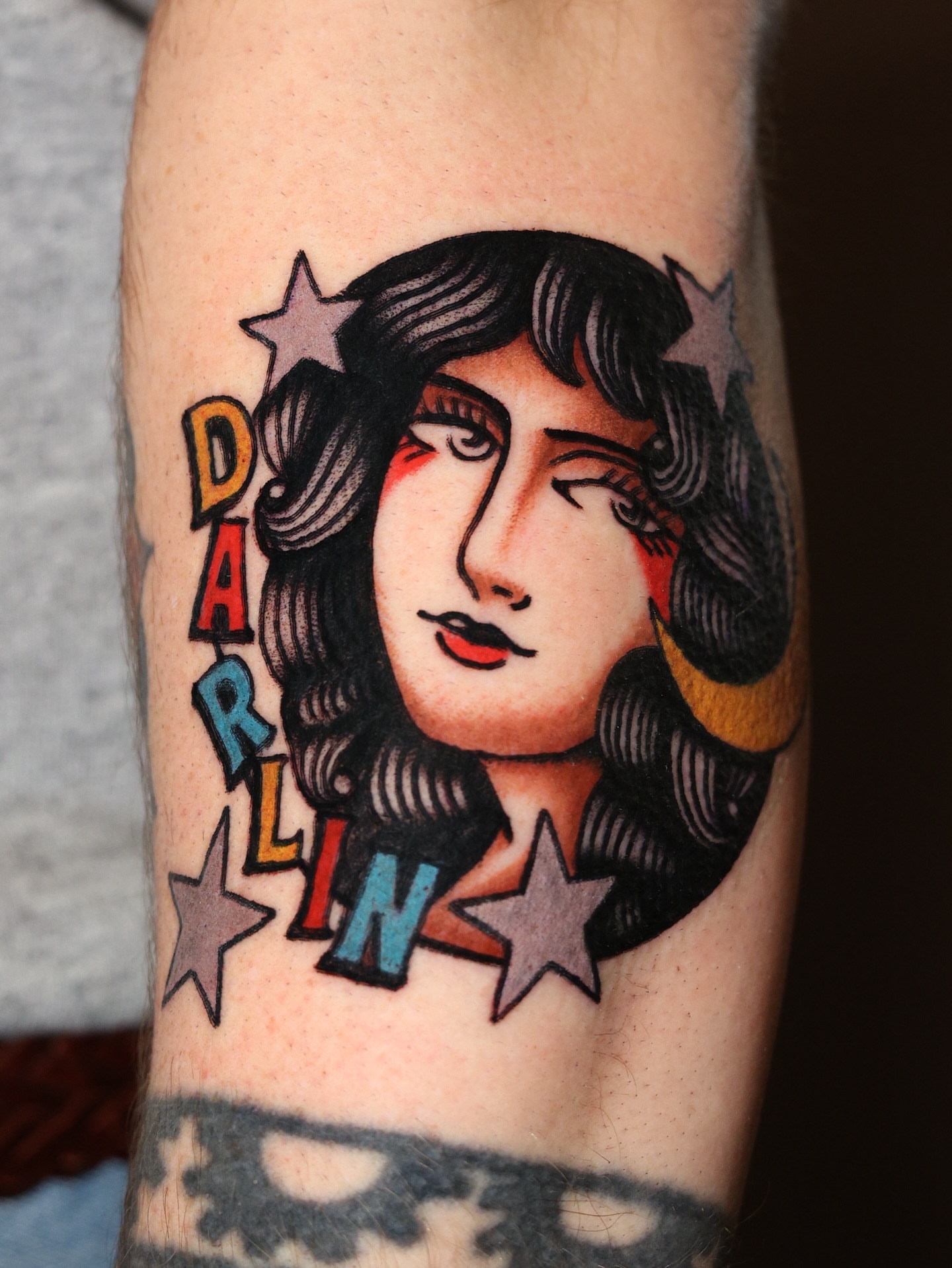 Woman's face American traditional tattoo on the forearm by Dylan Mott