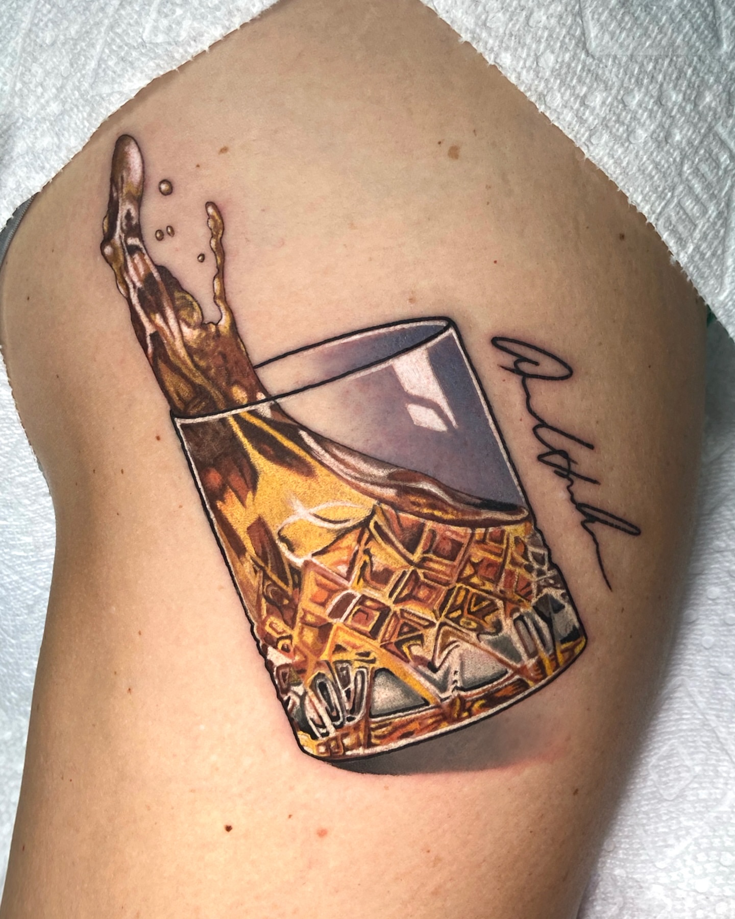 Whiskey glass realism tattoo on the thigh by ππππππ