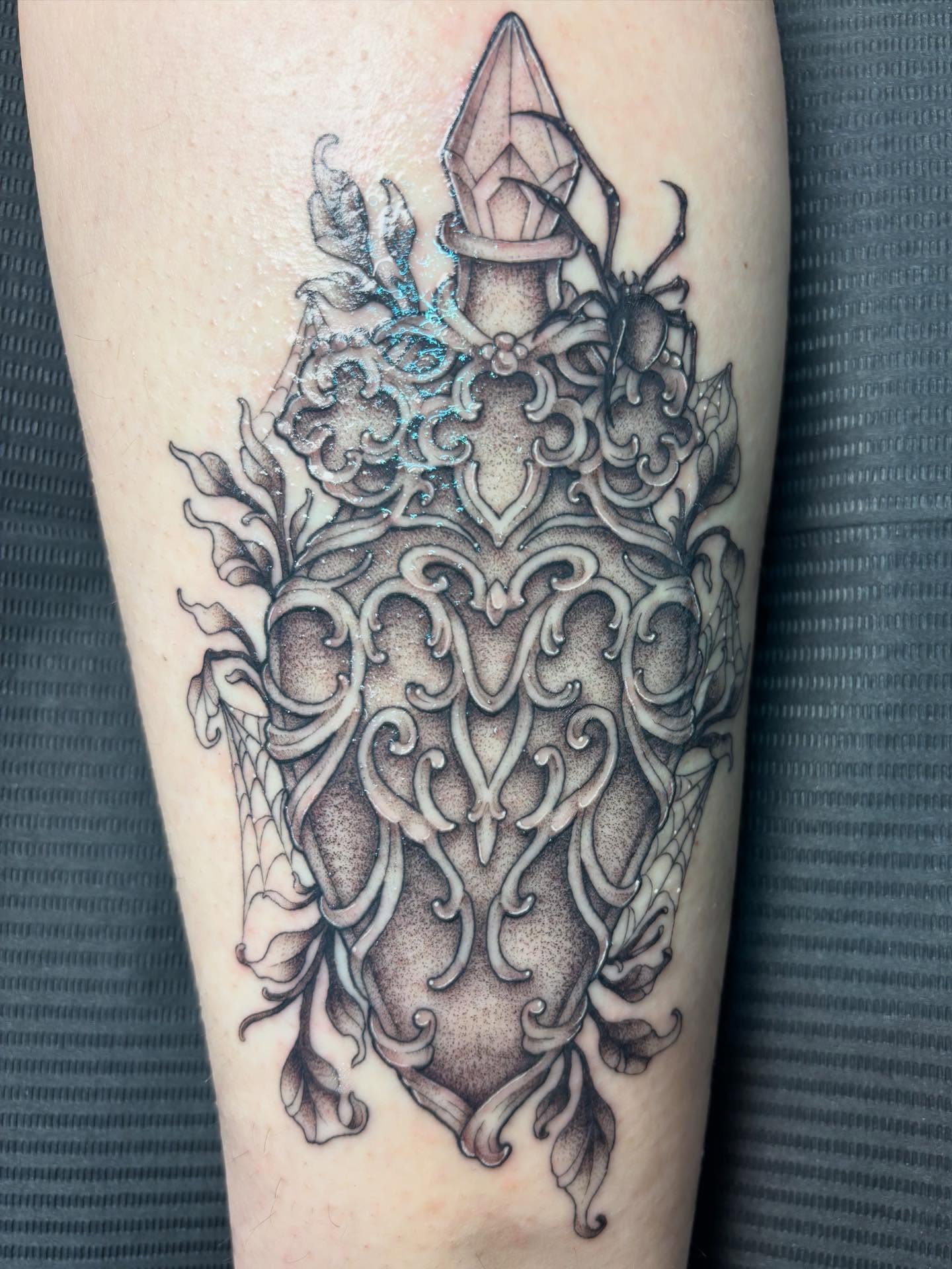 Ornate shield ornamental tattoo on the forearm by Rachel Foster