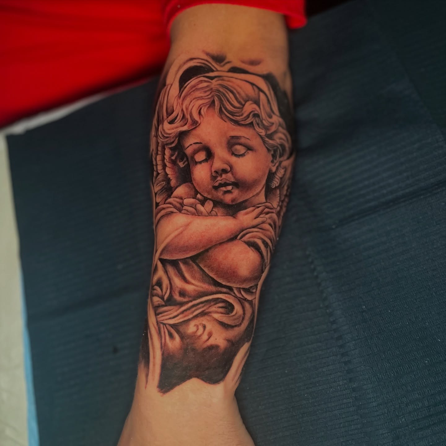 Angel realism tattoo on the forearm by Noriega Josué