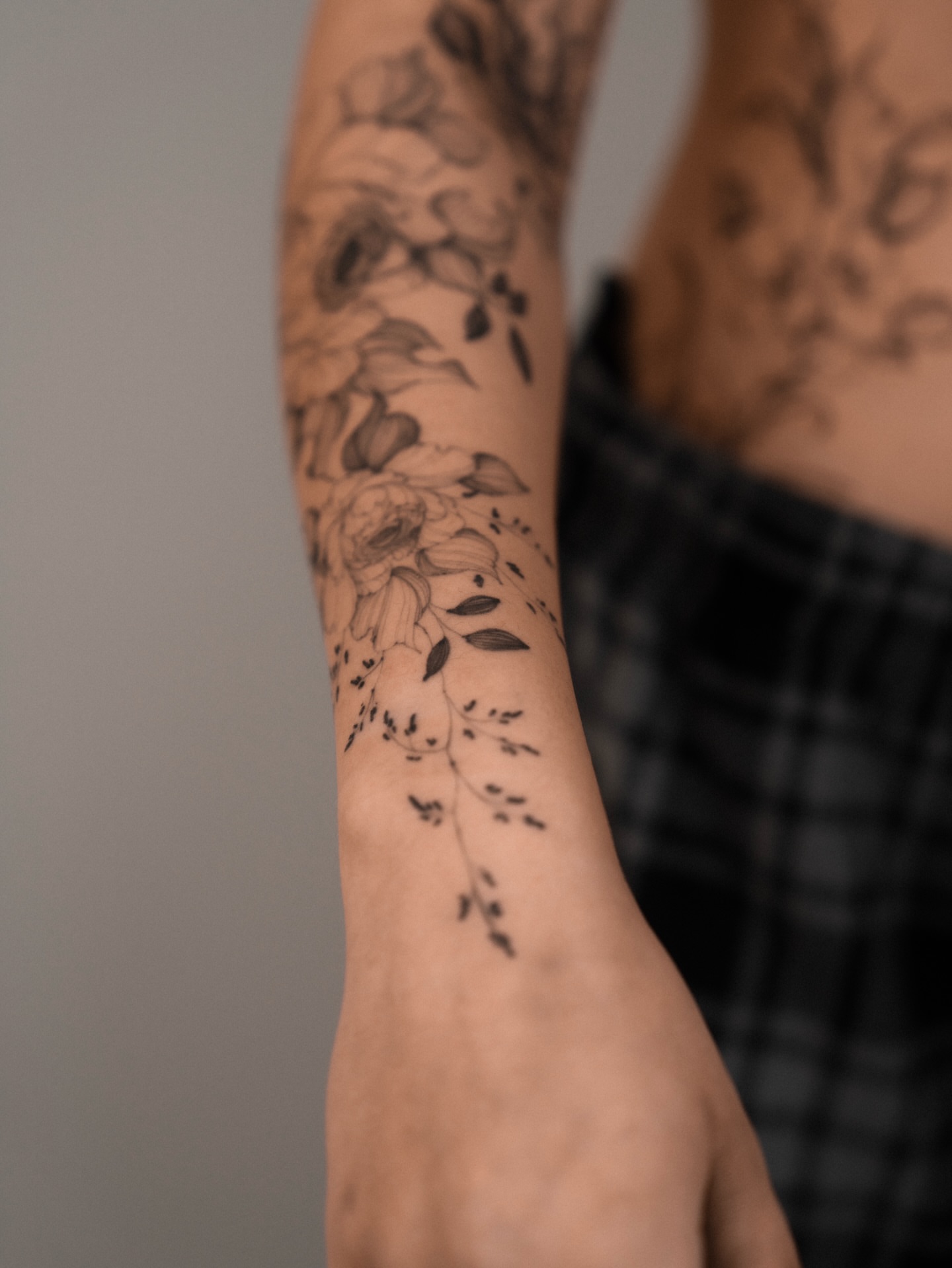 Floral arrangement black and grey tattoo on the forearm by Marek