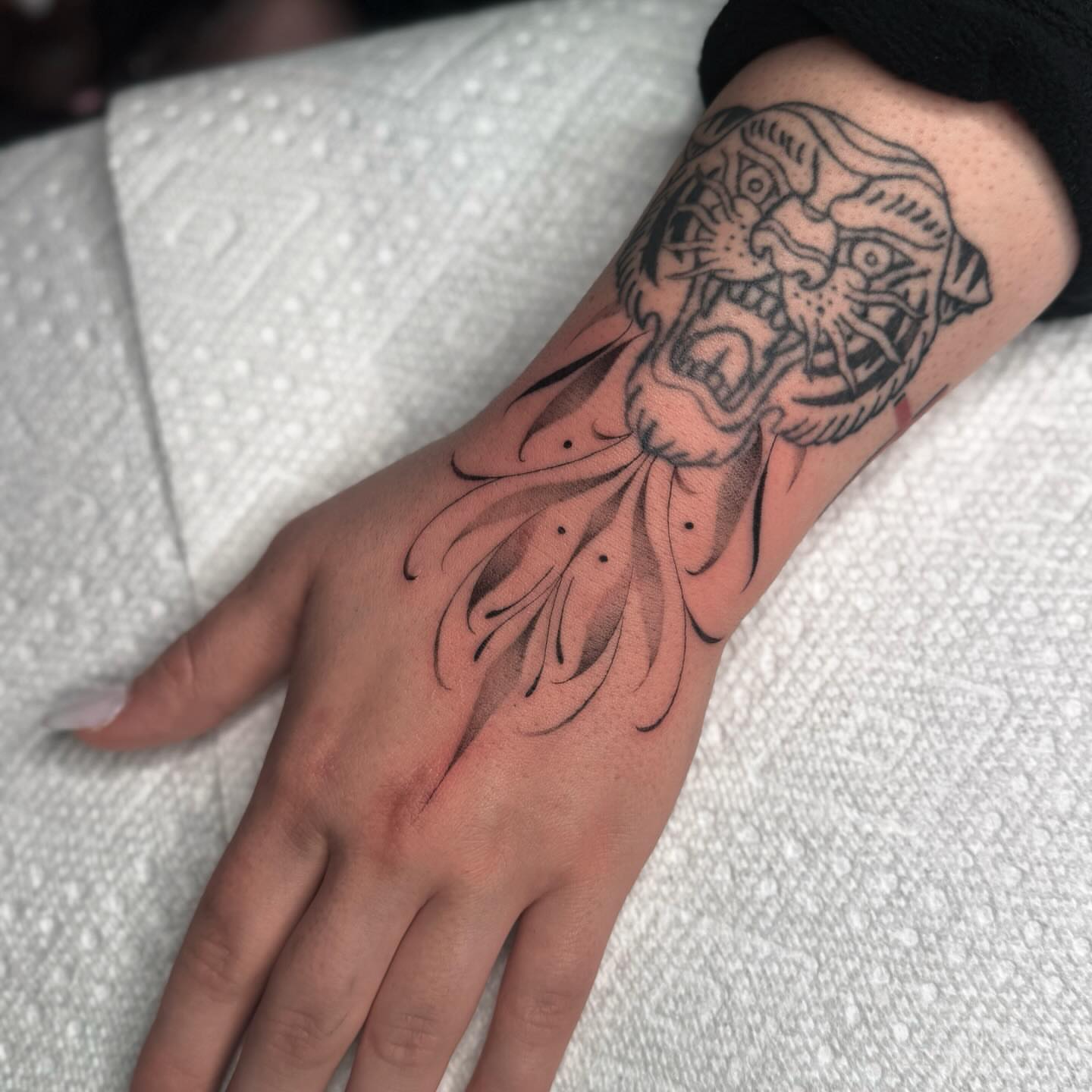 Tiger head black and grey tattoo on the forearm by Jas Knight