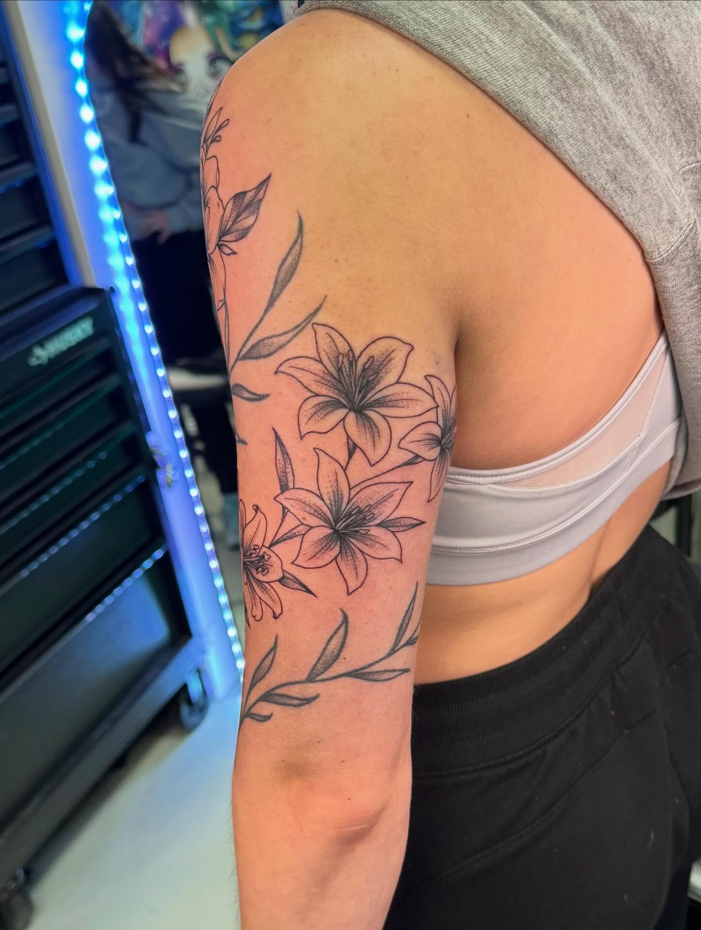 Lilies black and grey tattoo on the forearm by haylie