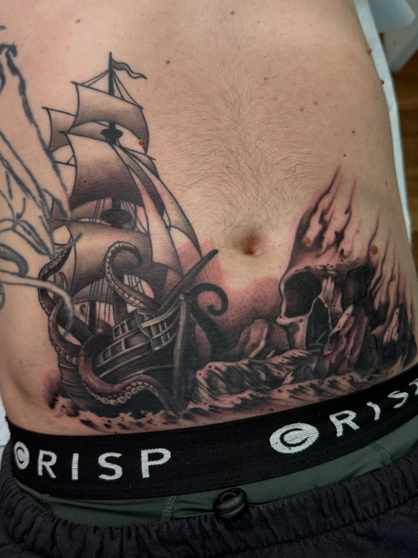 Ship and octopus American traditional tattoo on the ribs by Jeremy Utley