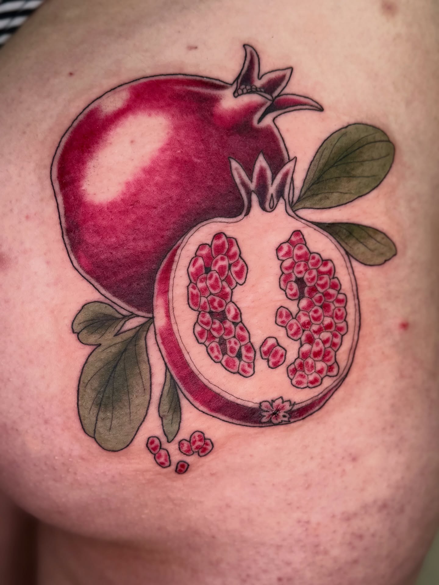 Pomegranate realism tattoo on the shoulder by Virginia 🥀Neo Traditional