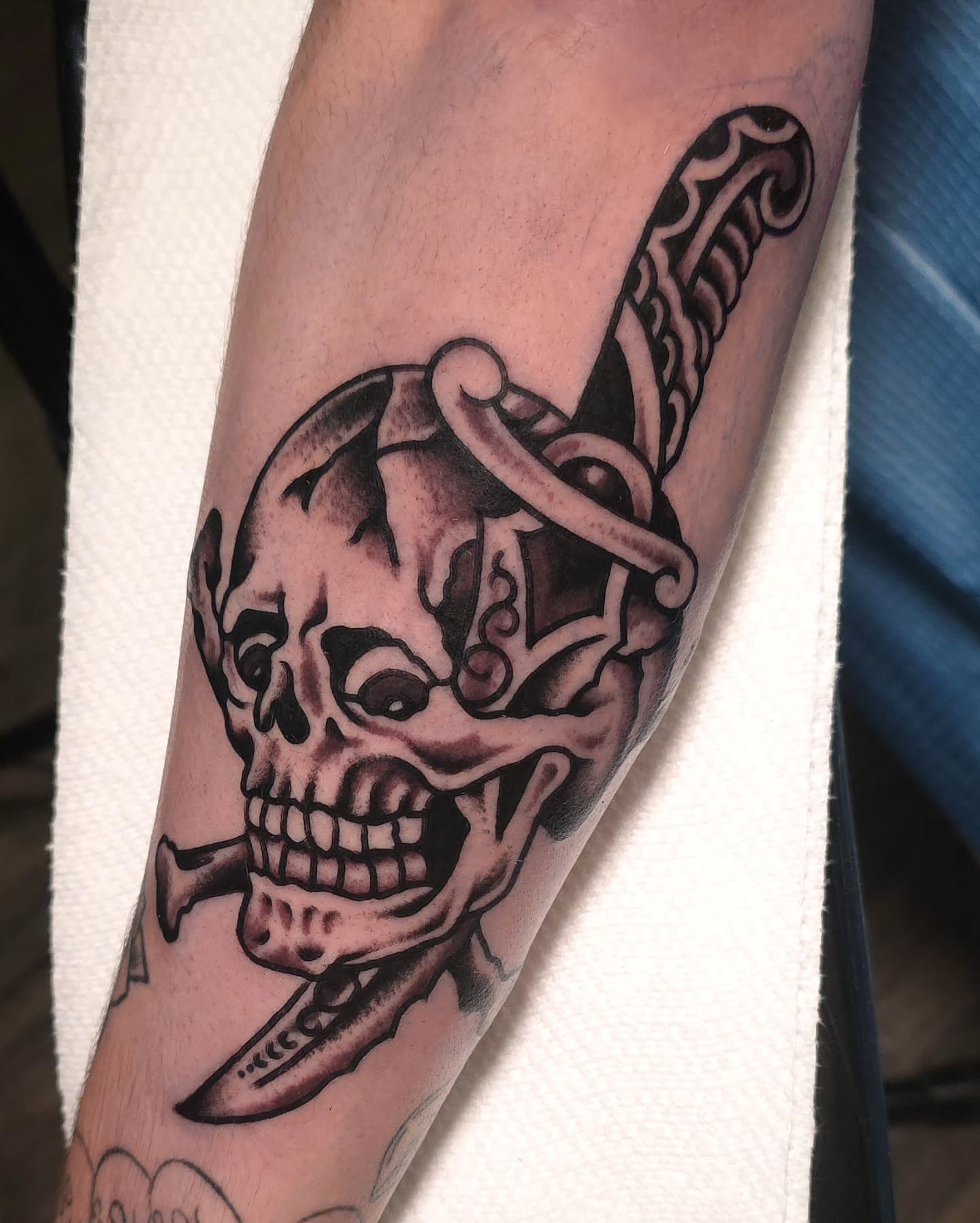 Skull and dagger black and grey tattoo on the forearm by J. Kirsch New Jersey Tattoo Artist