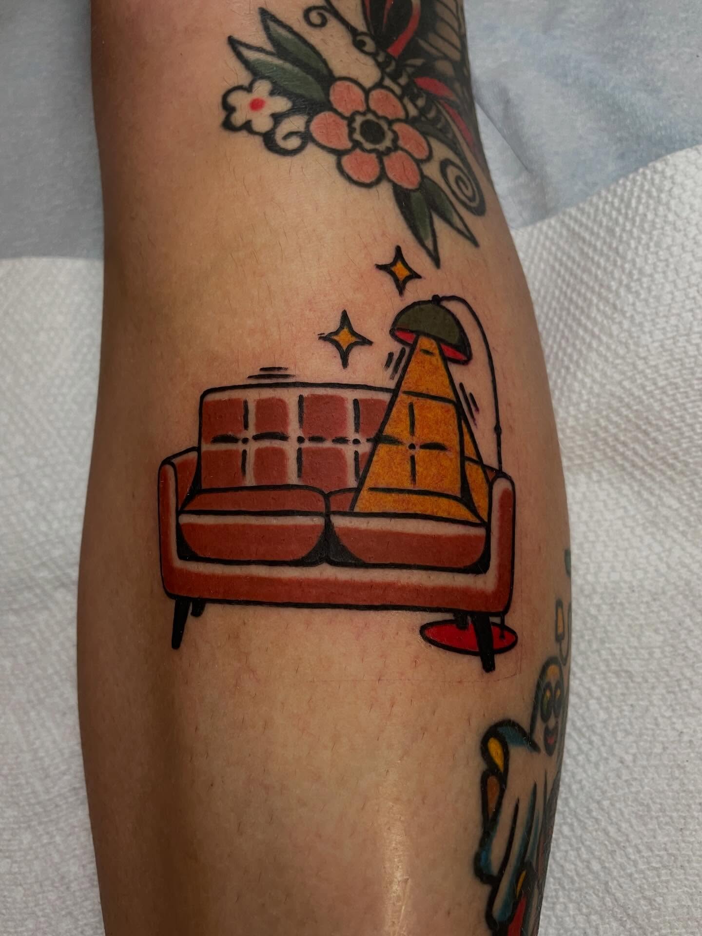Sofa and pyramid American traditional tattoo on the forearm by Jacob, Marion, Illinois